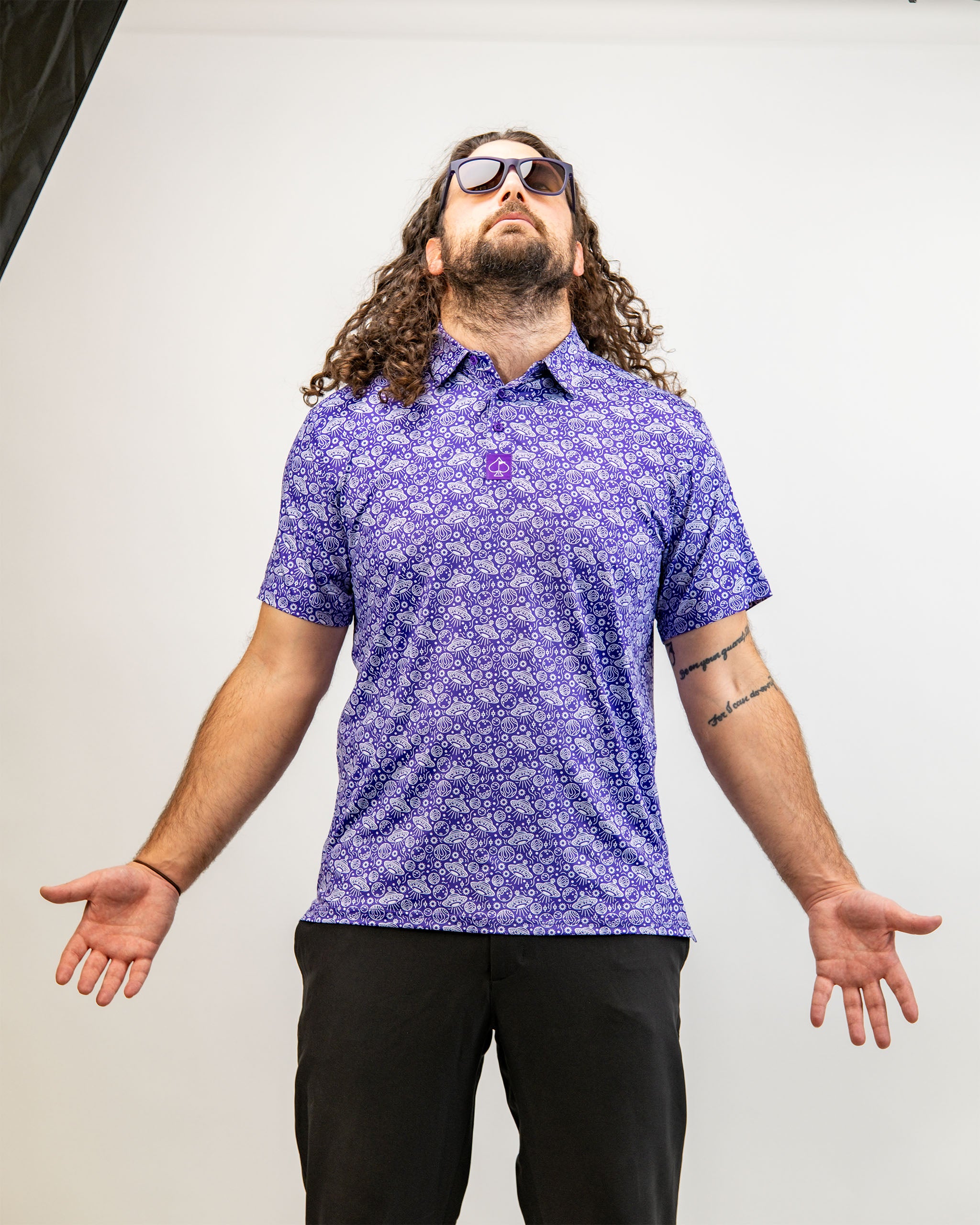 Men's HEYDUDE Indigolactic polo shirt displayed on a model, showcasing its vibrant blue color and casual fit.