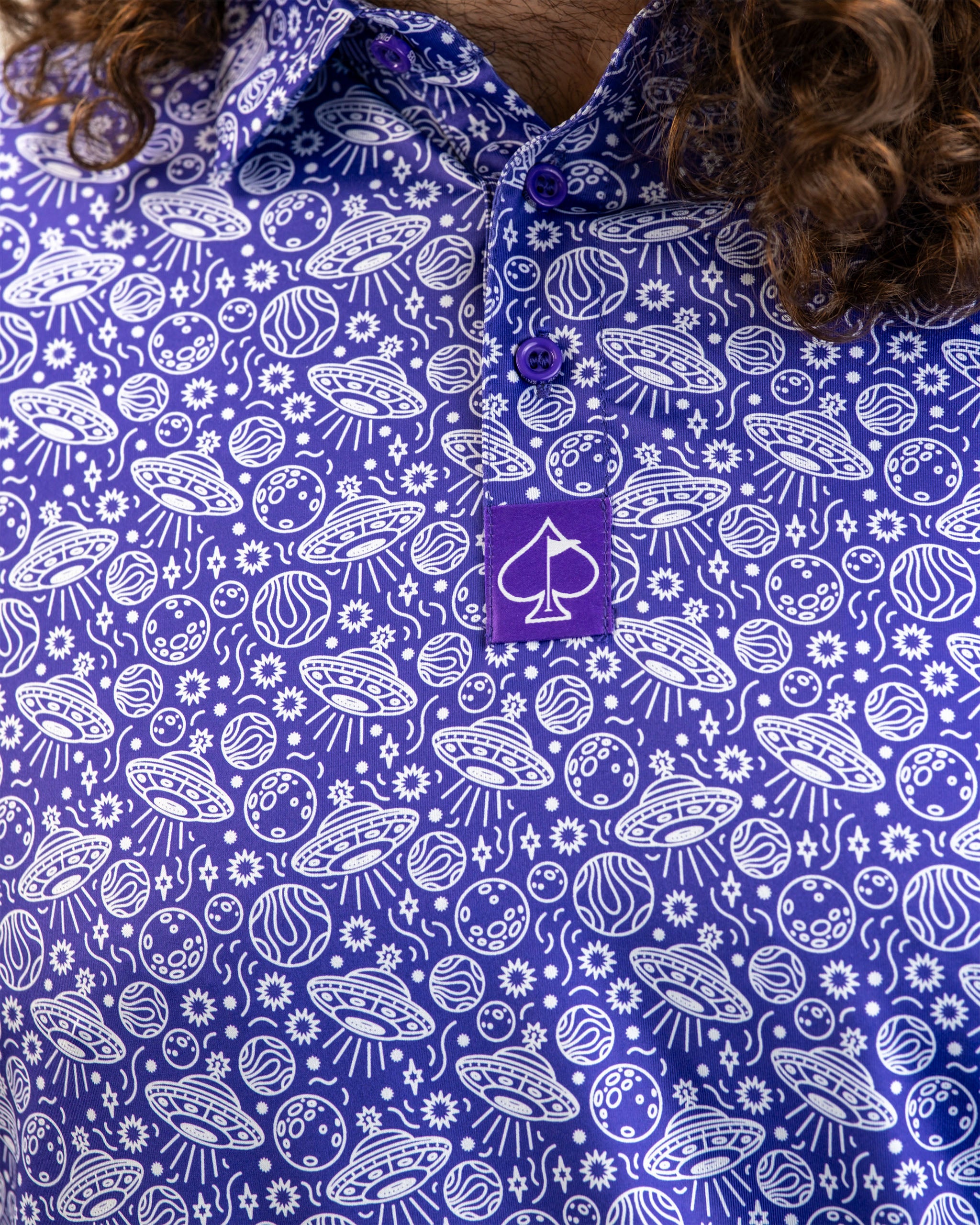 Men's HEYDUDE Indigolactic polo shirt, featuring a blue color and relaxed fit, modeled in a studio setting.