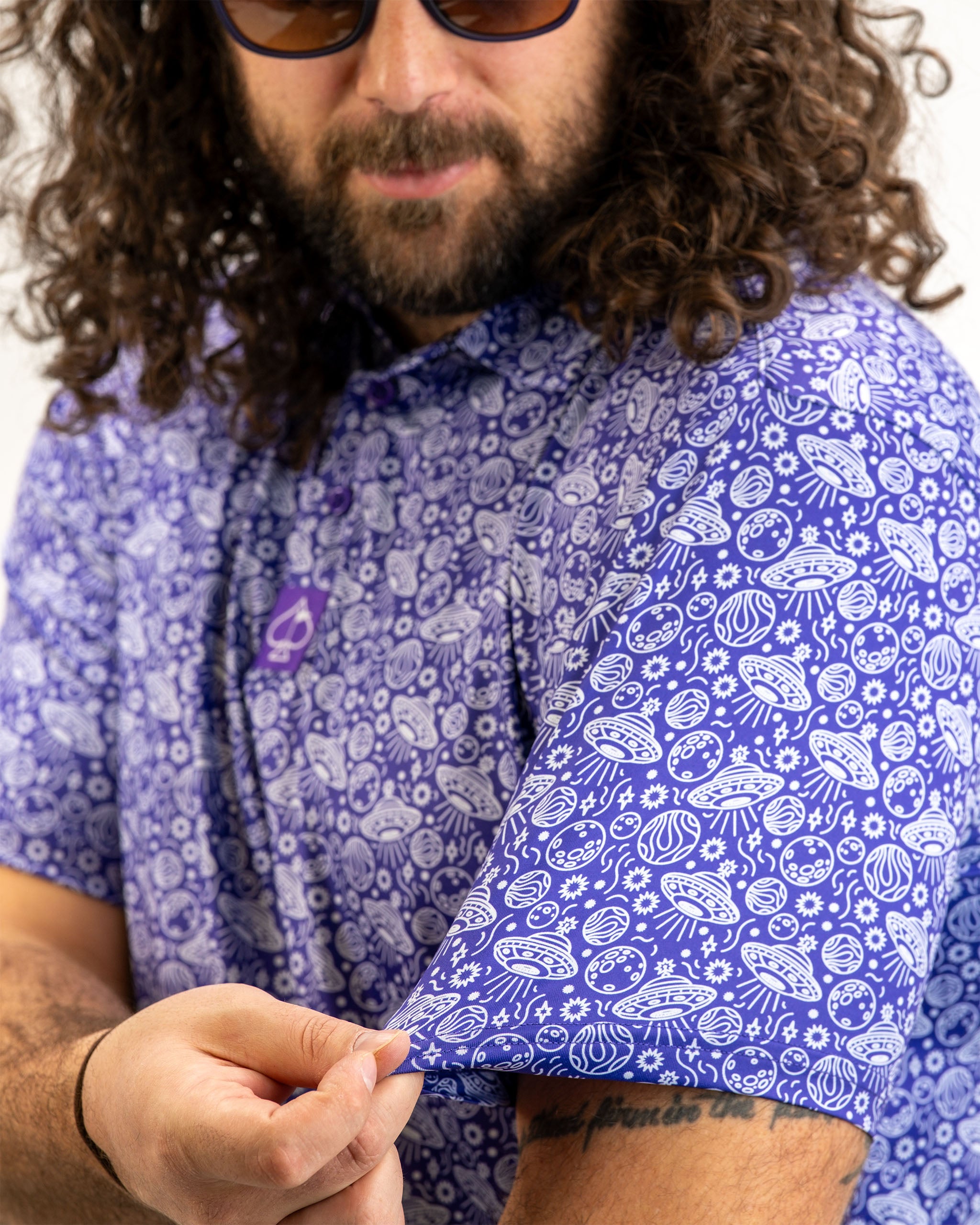 Men's HEYDUDE Indigolactic polo shirt displayed on a model, featuring a vibrant indigo color and a relaxed fit.