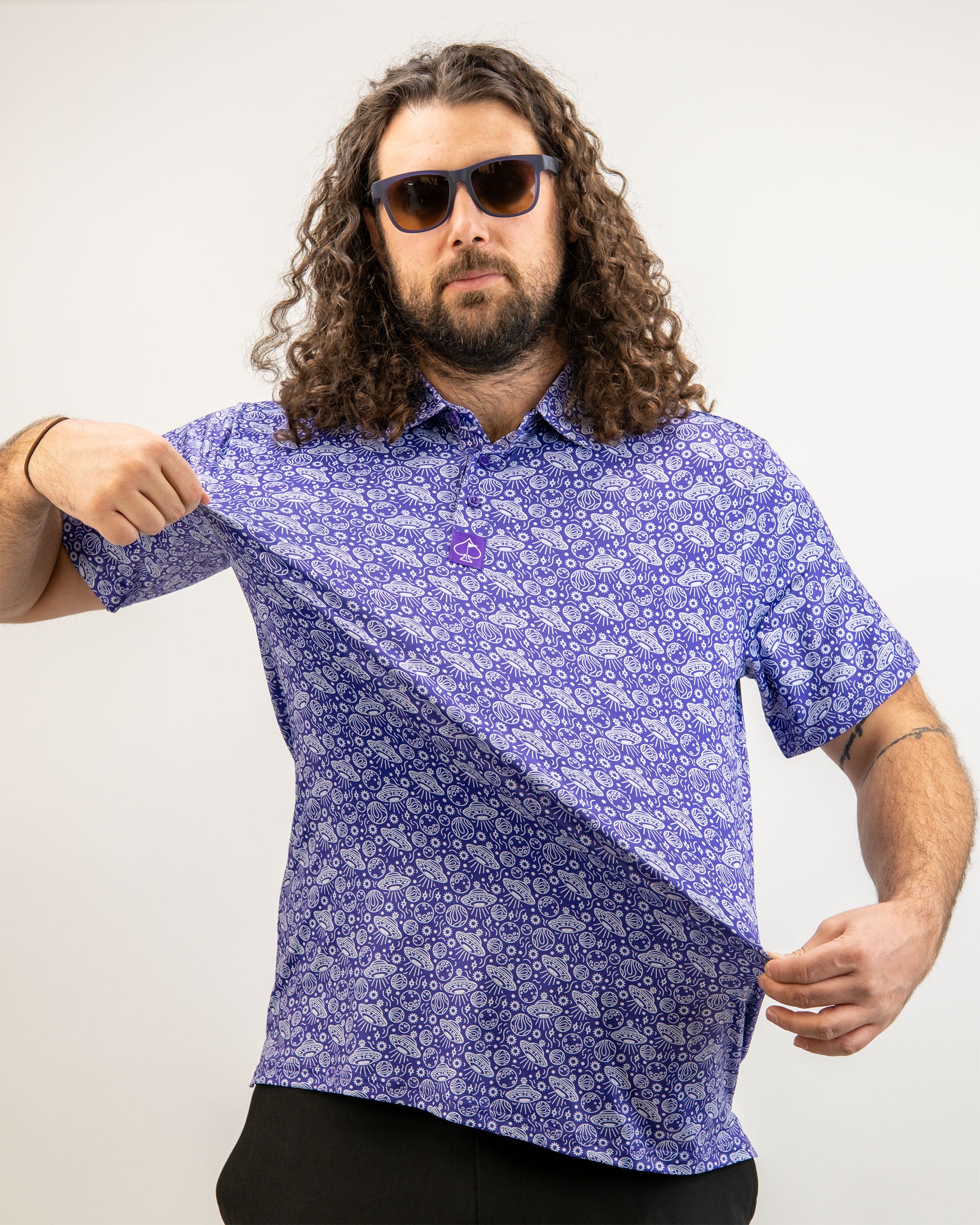 Men's HEYDUDE Indigolactic polo shirt displayed on a model, featuring a vibrant indigo color and a relaxed fit.