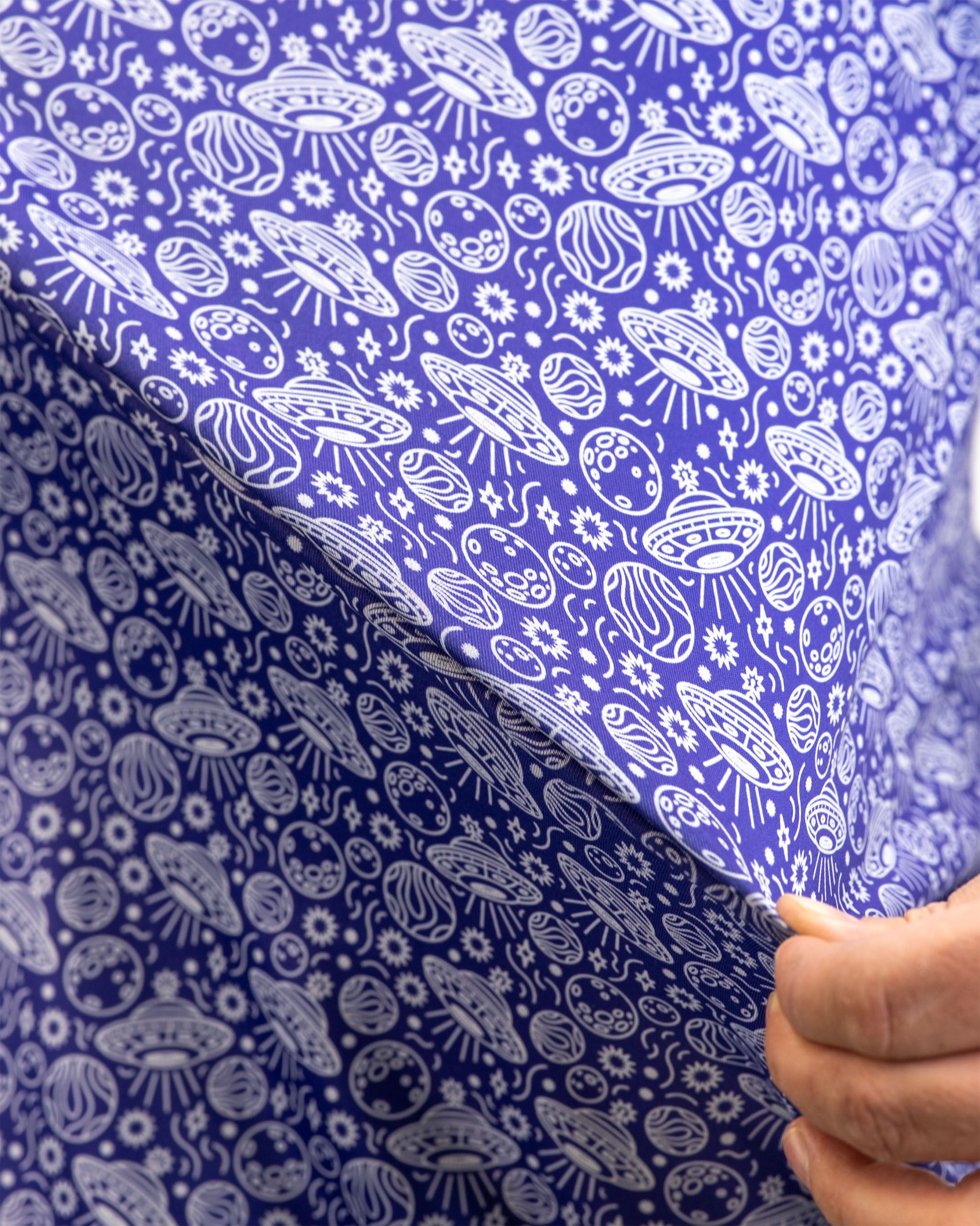 Men's HEYDUDE Indigolactic polo shirt displayed on a model, featuring a vibrant blue color and casual style.