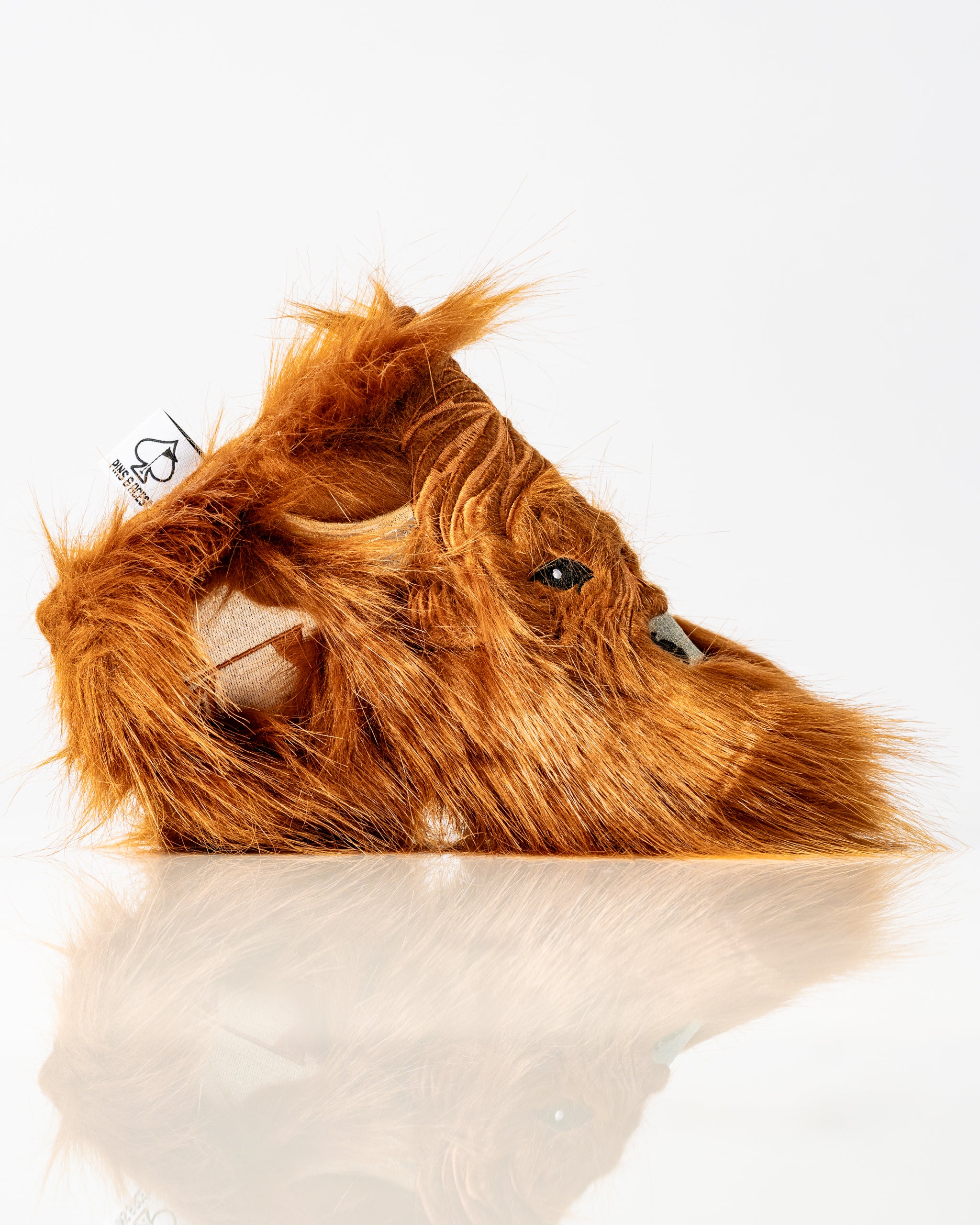 Highland cow blade putter cover with a furry texture and detailed facial features, perfect for unique golf accessories.