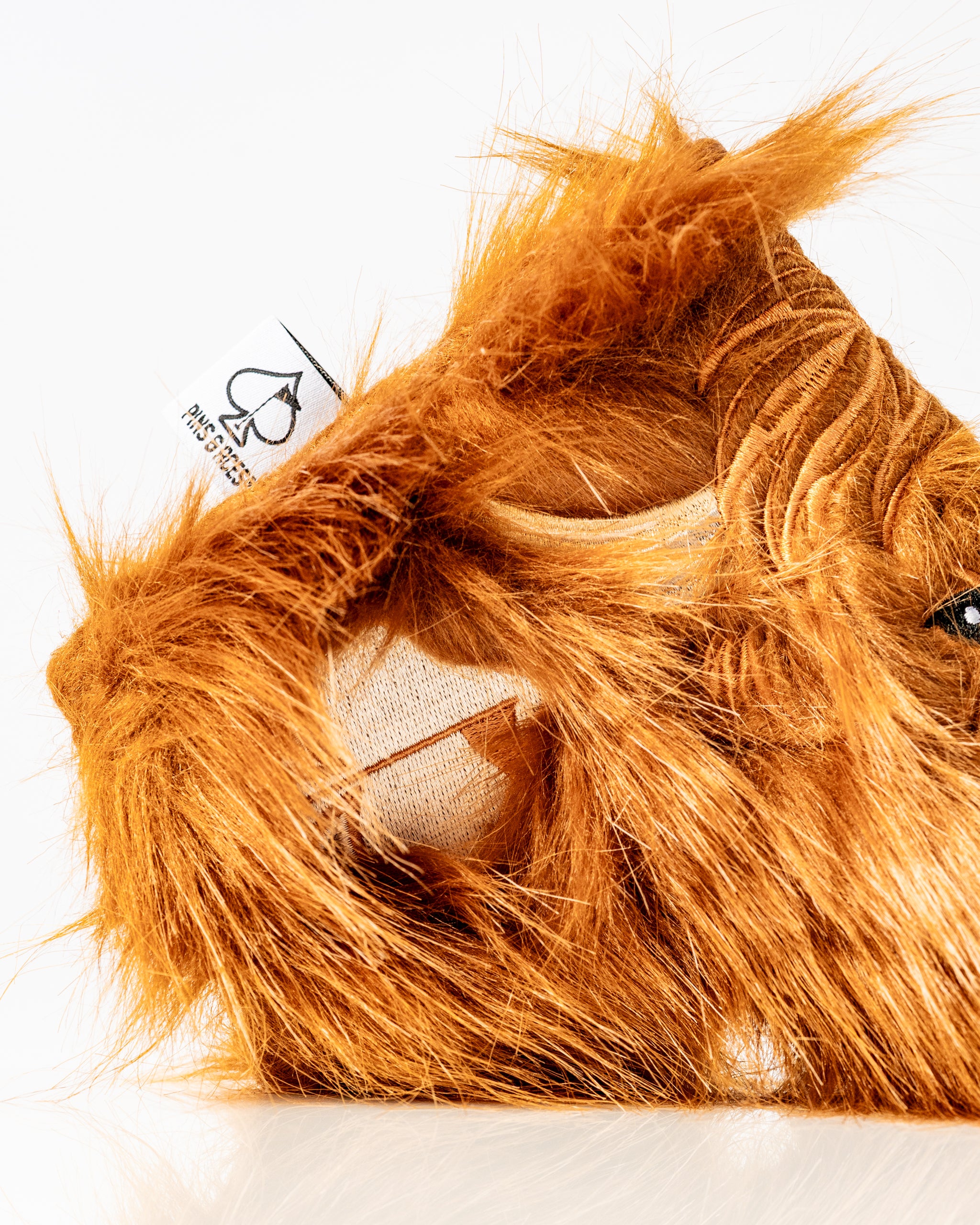 Highland cow blade putter cover with vibrant orange fur, designed to add a unique touch to your golf gear.
