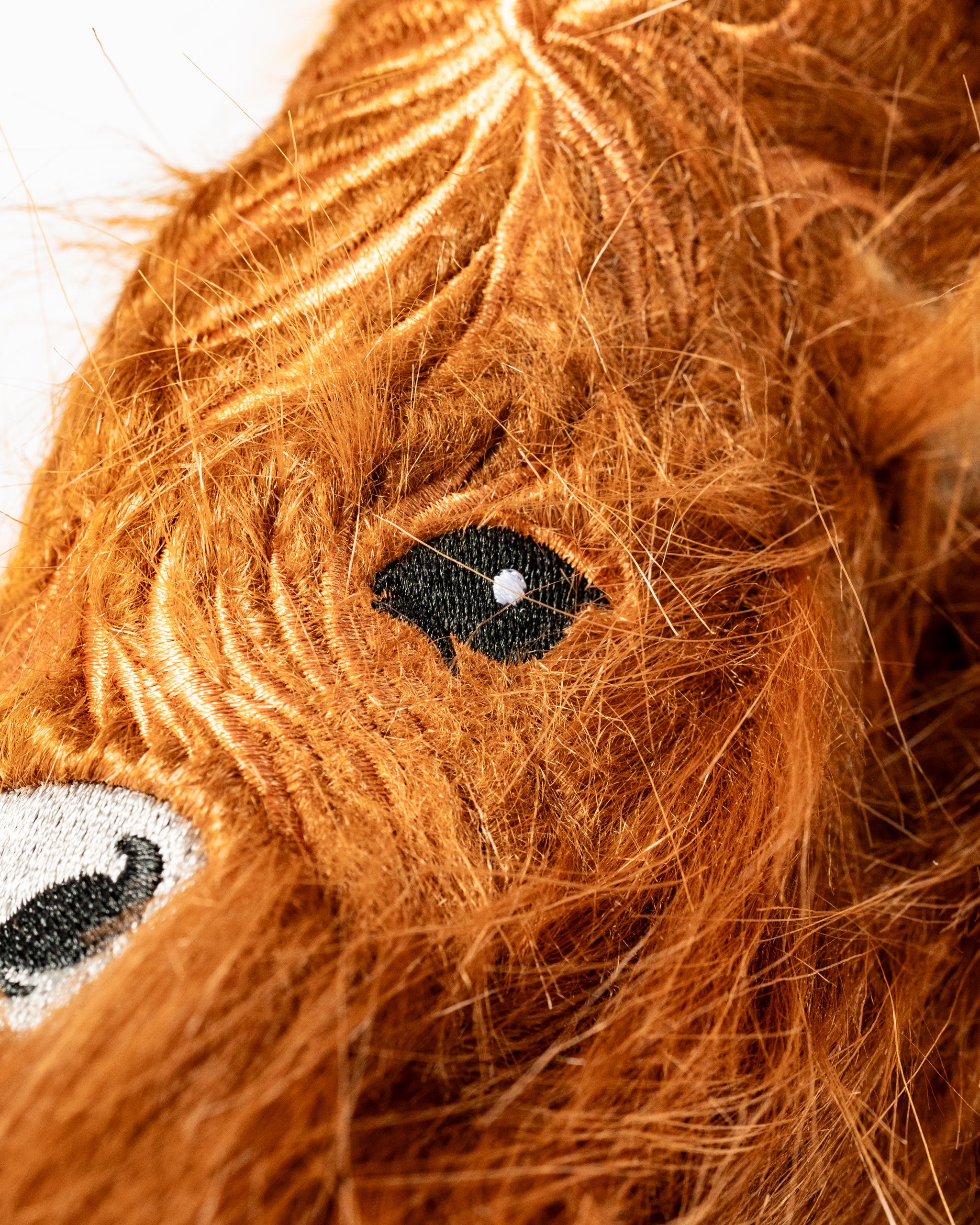 Highland cow blade putter cover featuring realistic fur texture and embroidered eyes, perfect for unique golf style.