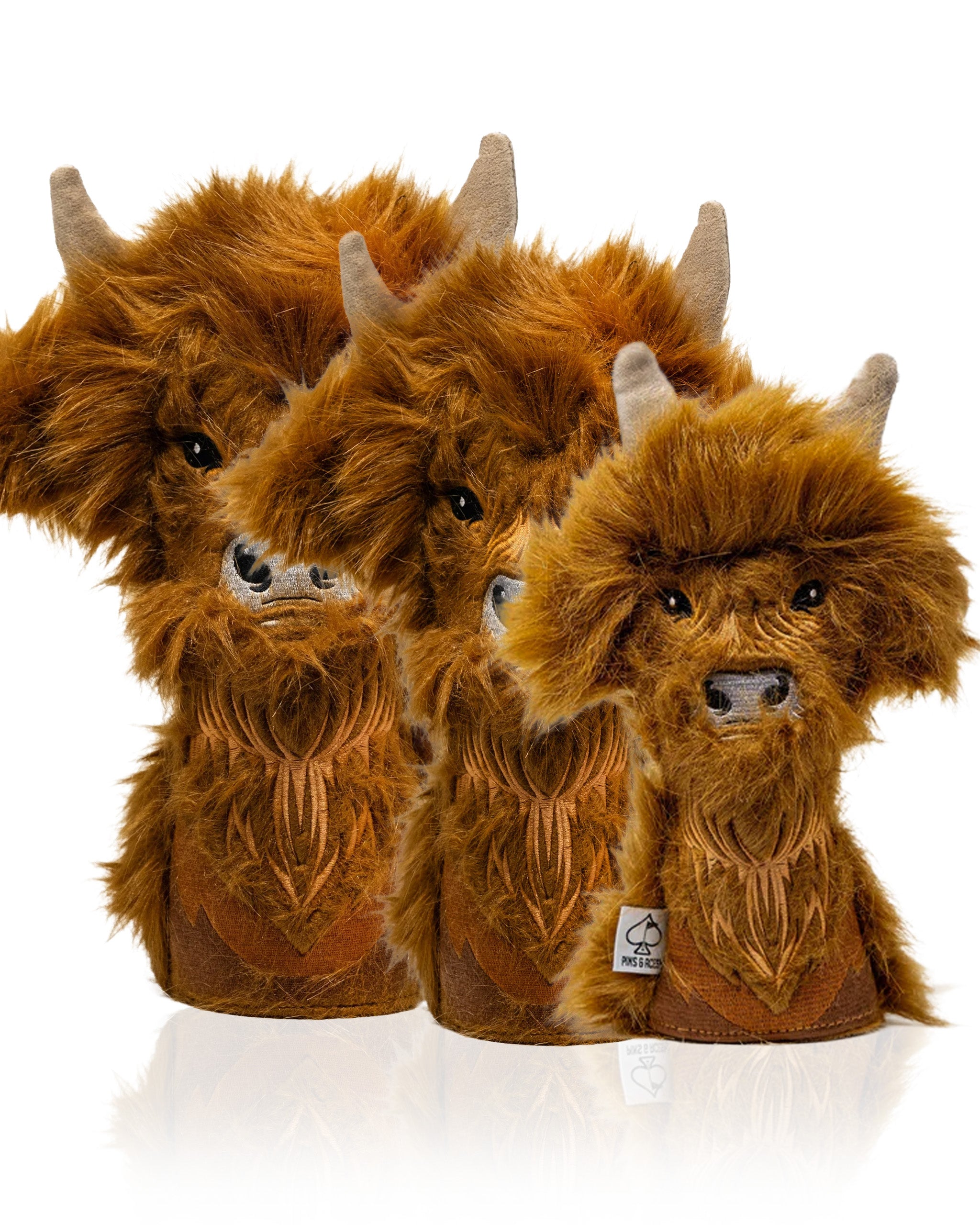 Highland cow headcover set featuring three plush headcovers with detailed fur and horns, perfect for golfers seeking unique style.