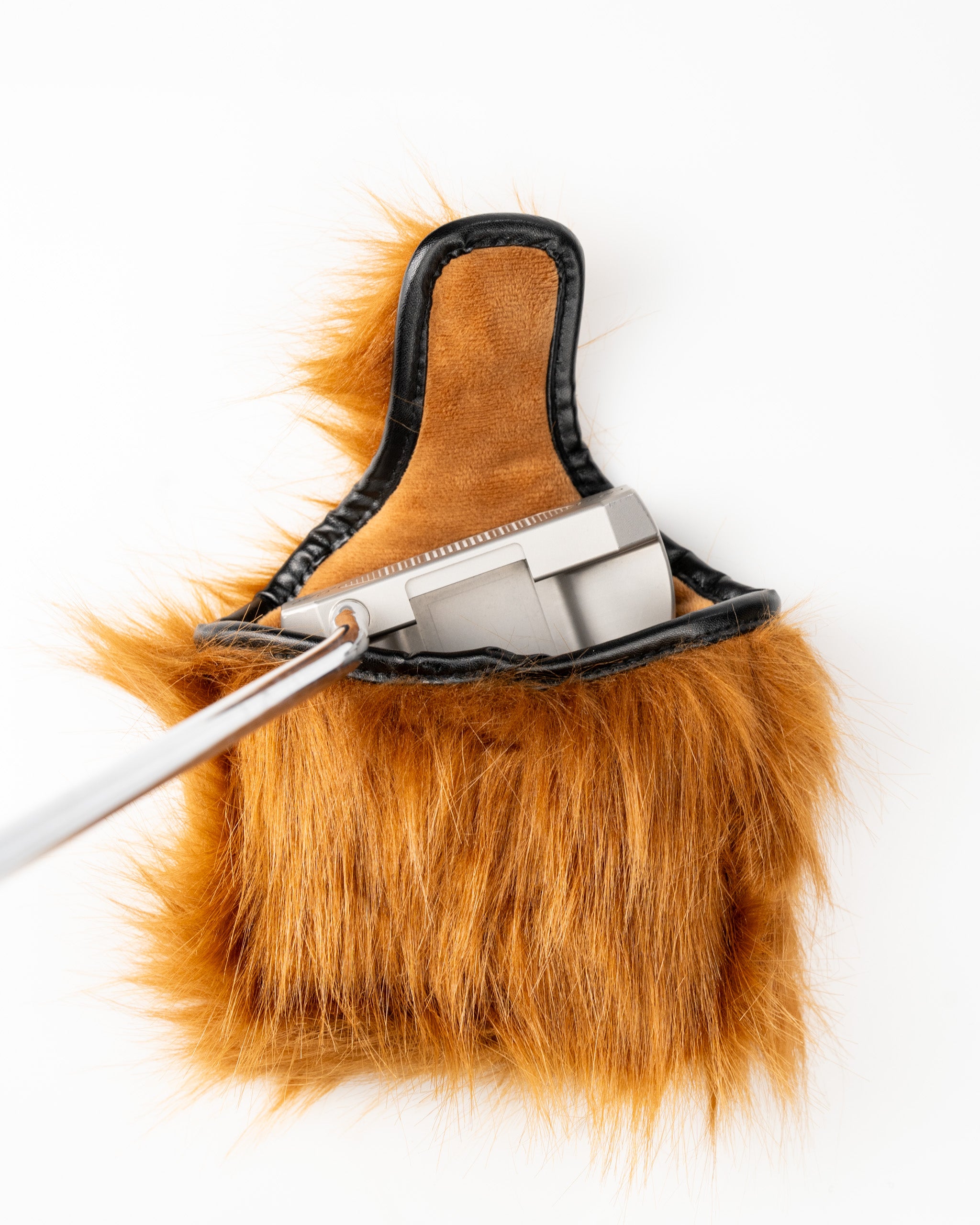 Highland cow mallet putter cover in orange fur, showcasing a putter partially inserted for a unique golf accessory look.