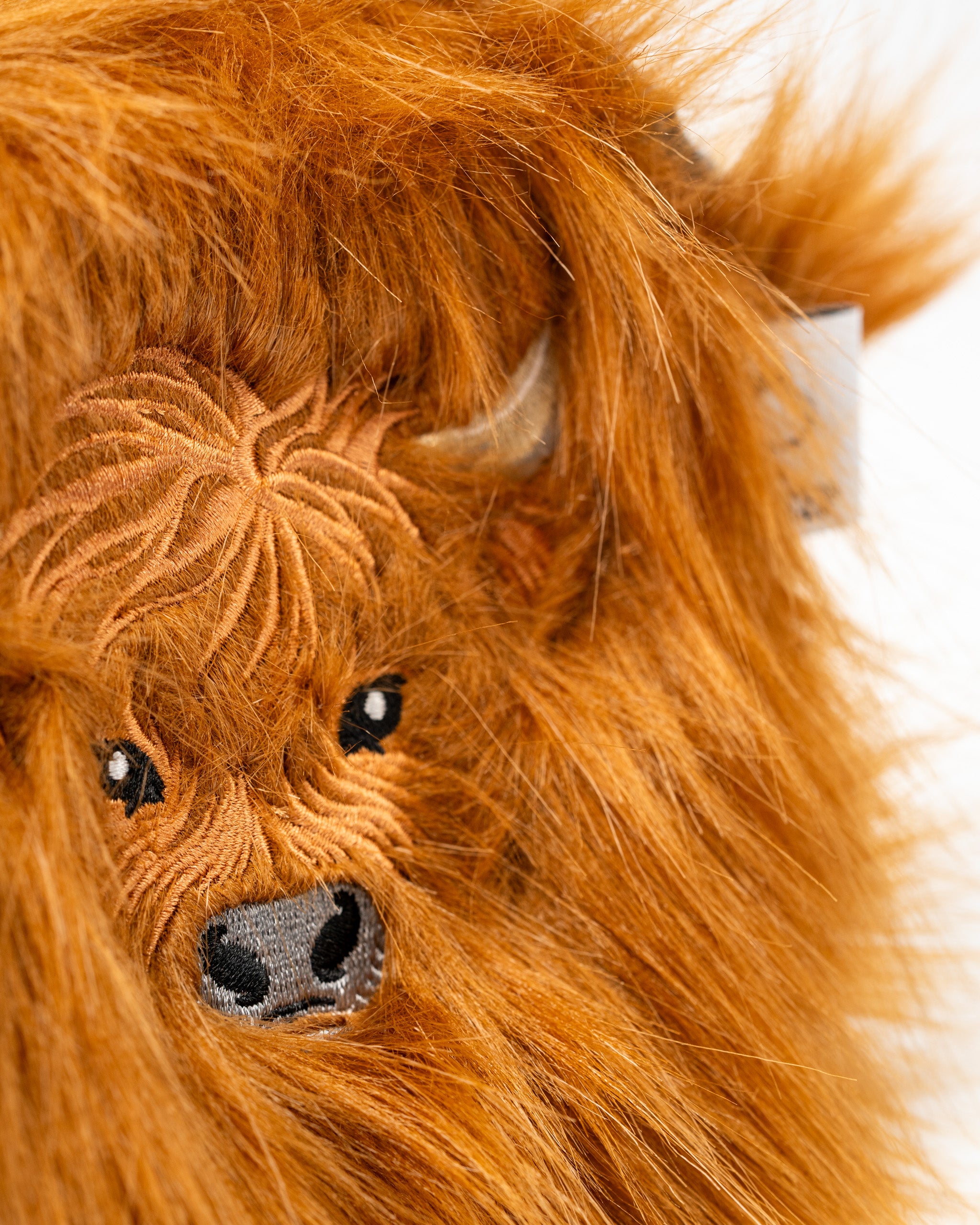 Highland cow mallet putter cover featuring detailed embroidery and a fluffy orange design for a unique golf accessory.