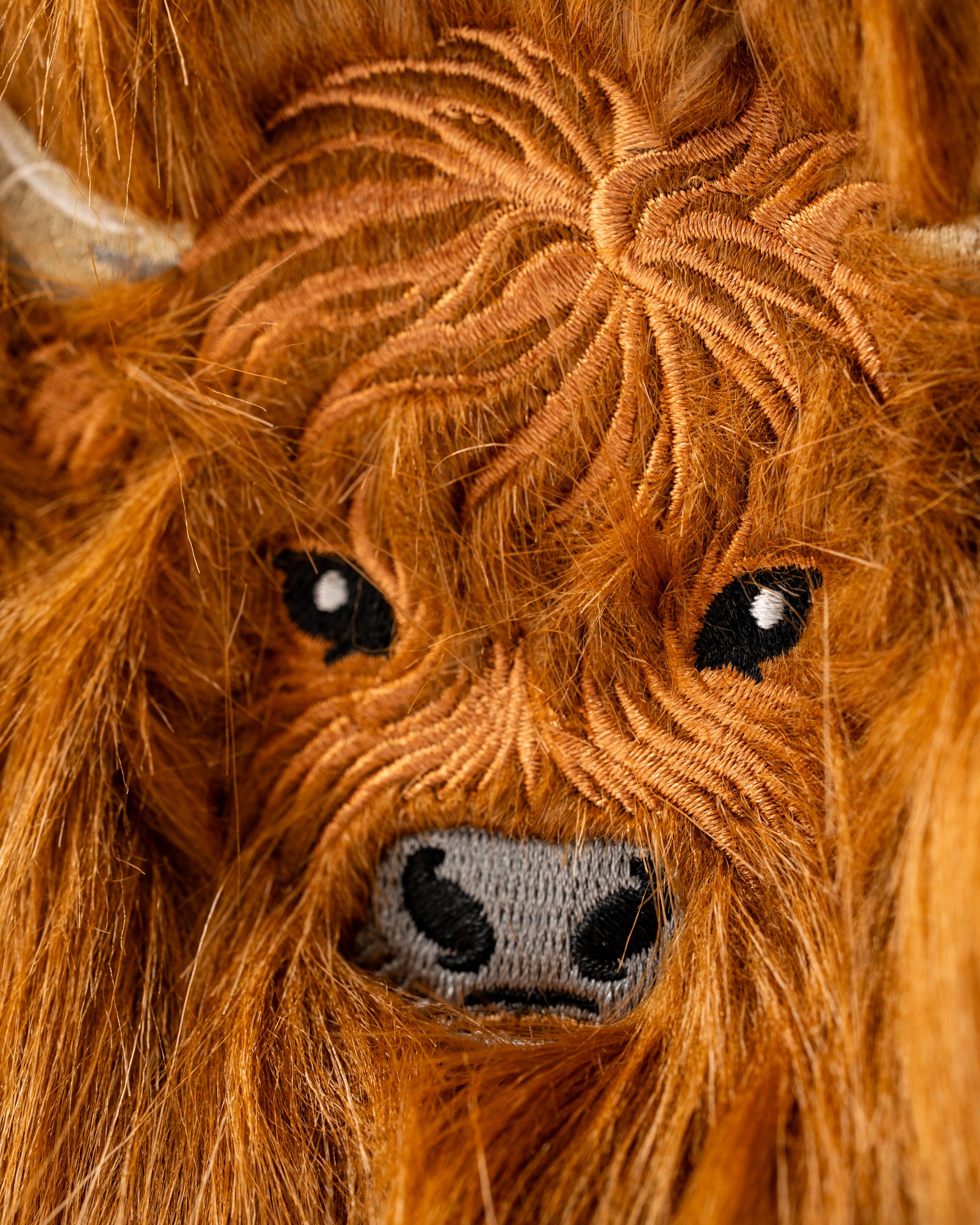 Highland cow mallet putter cover featuring detailed embroidery and a vibrant orange fur texture for a unique golf accessory.