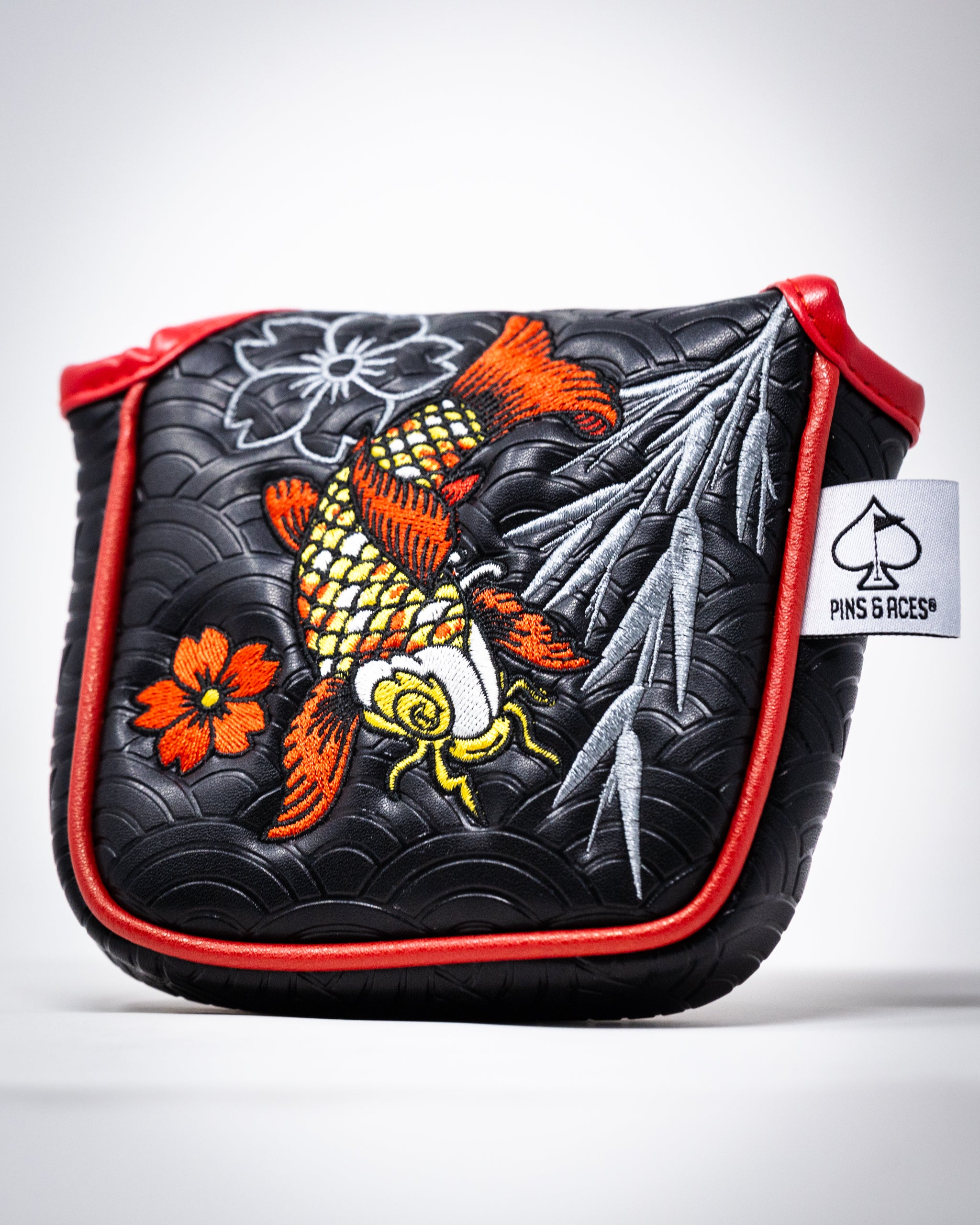 Koi Flow mallet putter cover featuring a vibrant koi fish design on a black background.