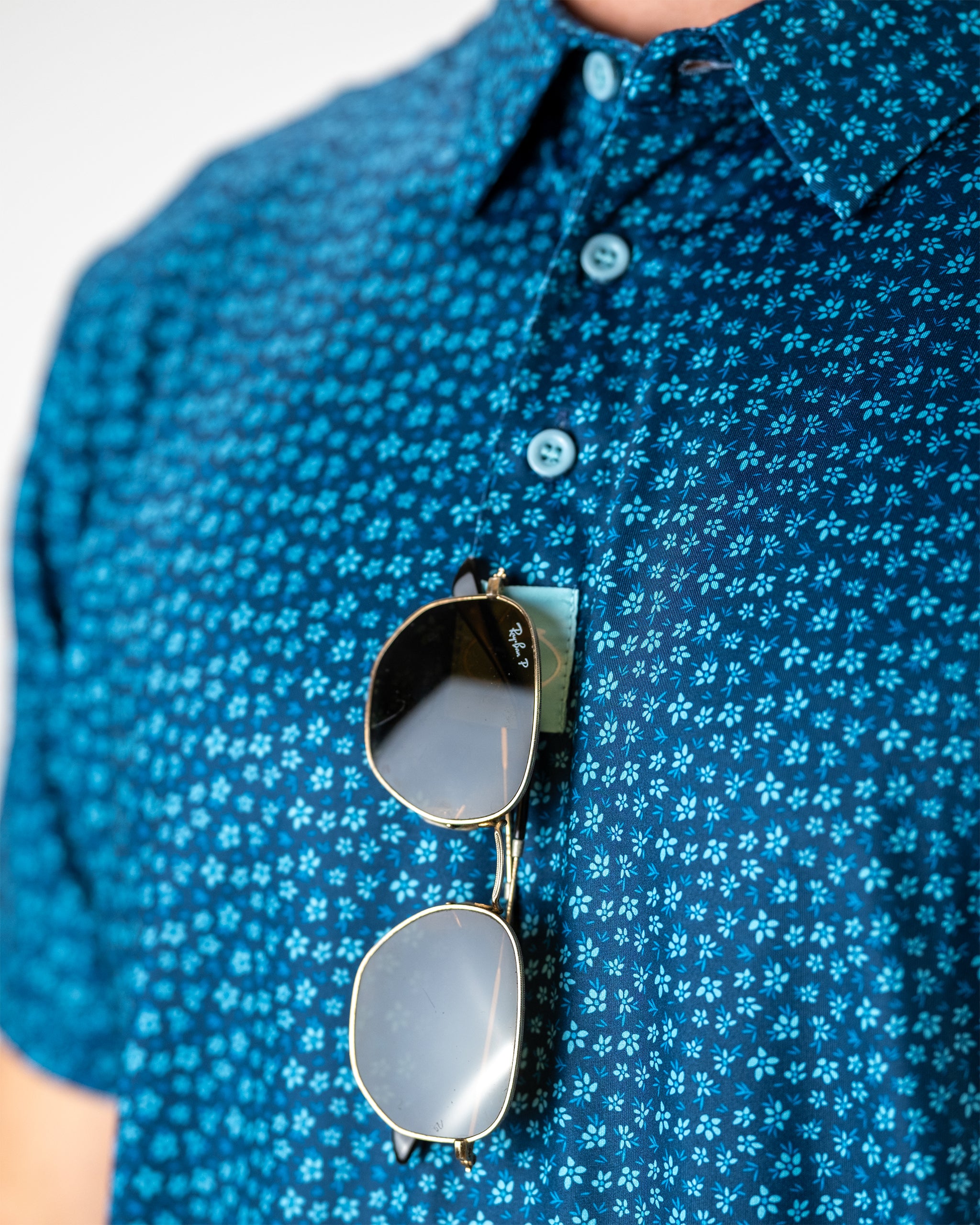 Micro Floral pattern in shades of blue on fabric, featuring delicate tiny flowers, ideal for fashion and home decor.