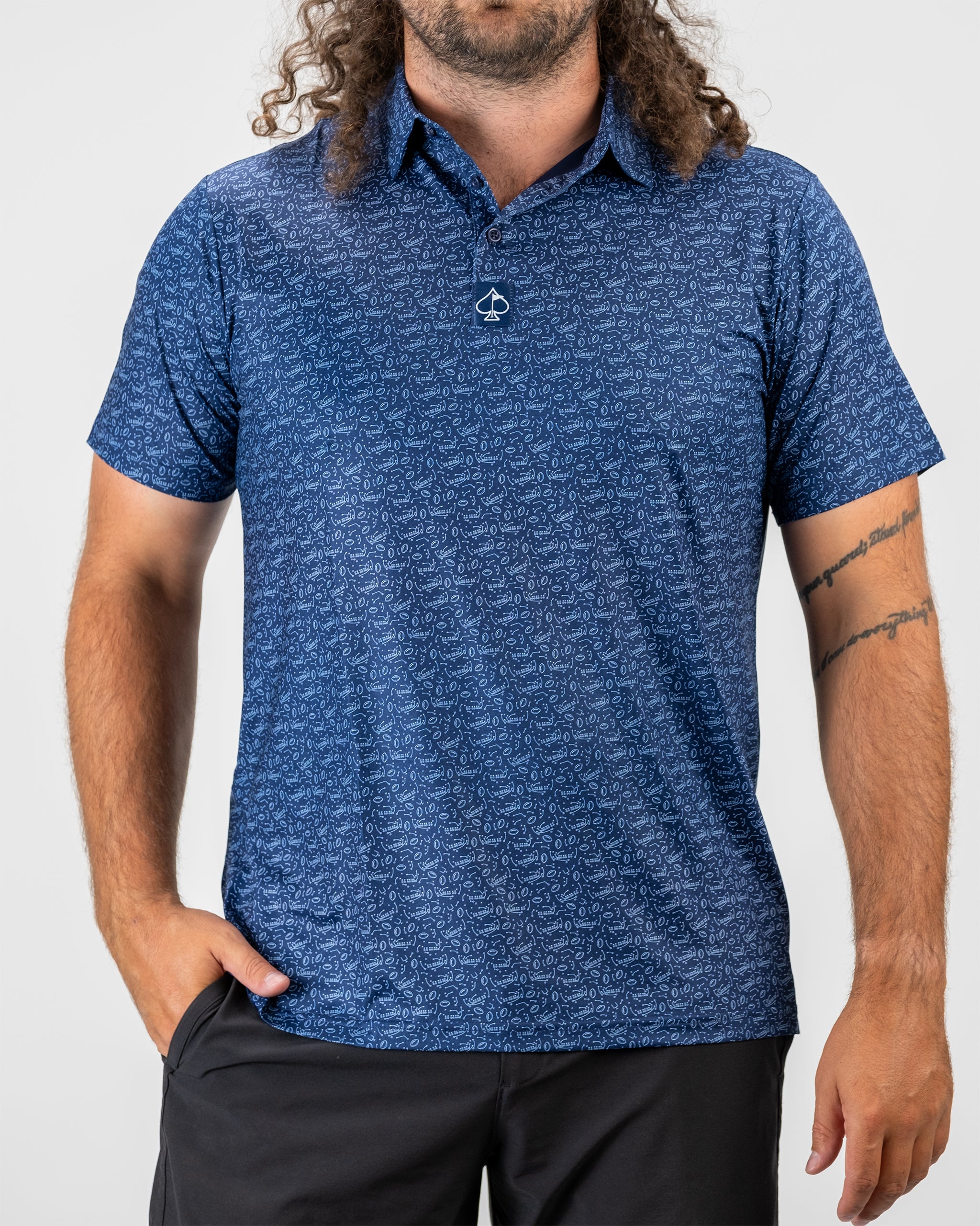 Person wearing the Playmaker athletic shirt featuring a dynamic design, standing confidently on a soccer field.