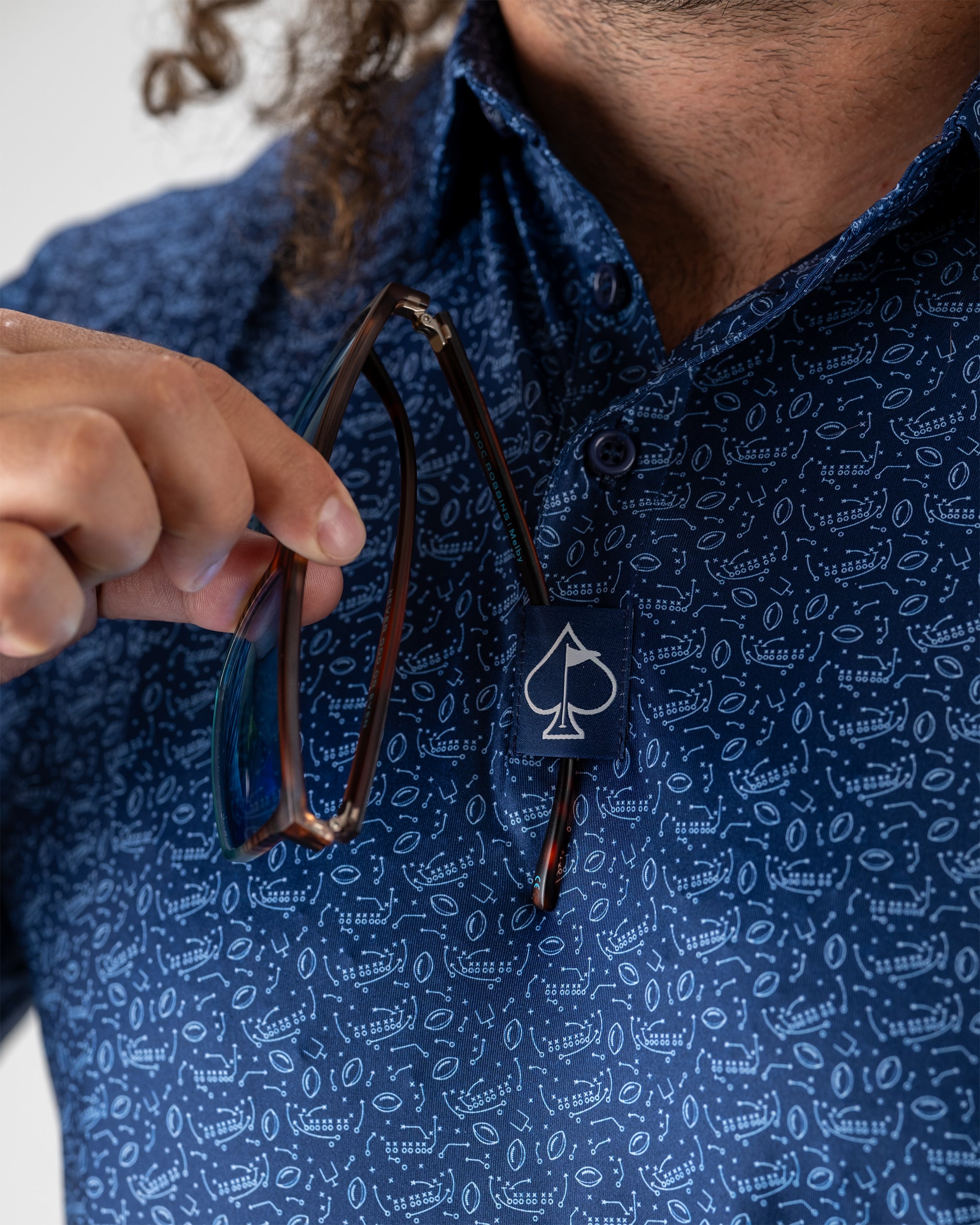 Model showcasing the Playmaker fishing tackle, featuring a sleek design and vibrant color scheme, set against a natural outdoor backdrop.