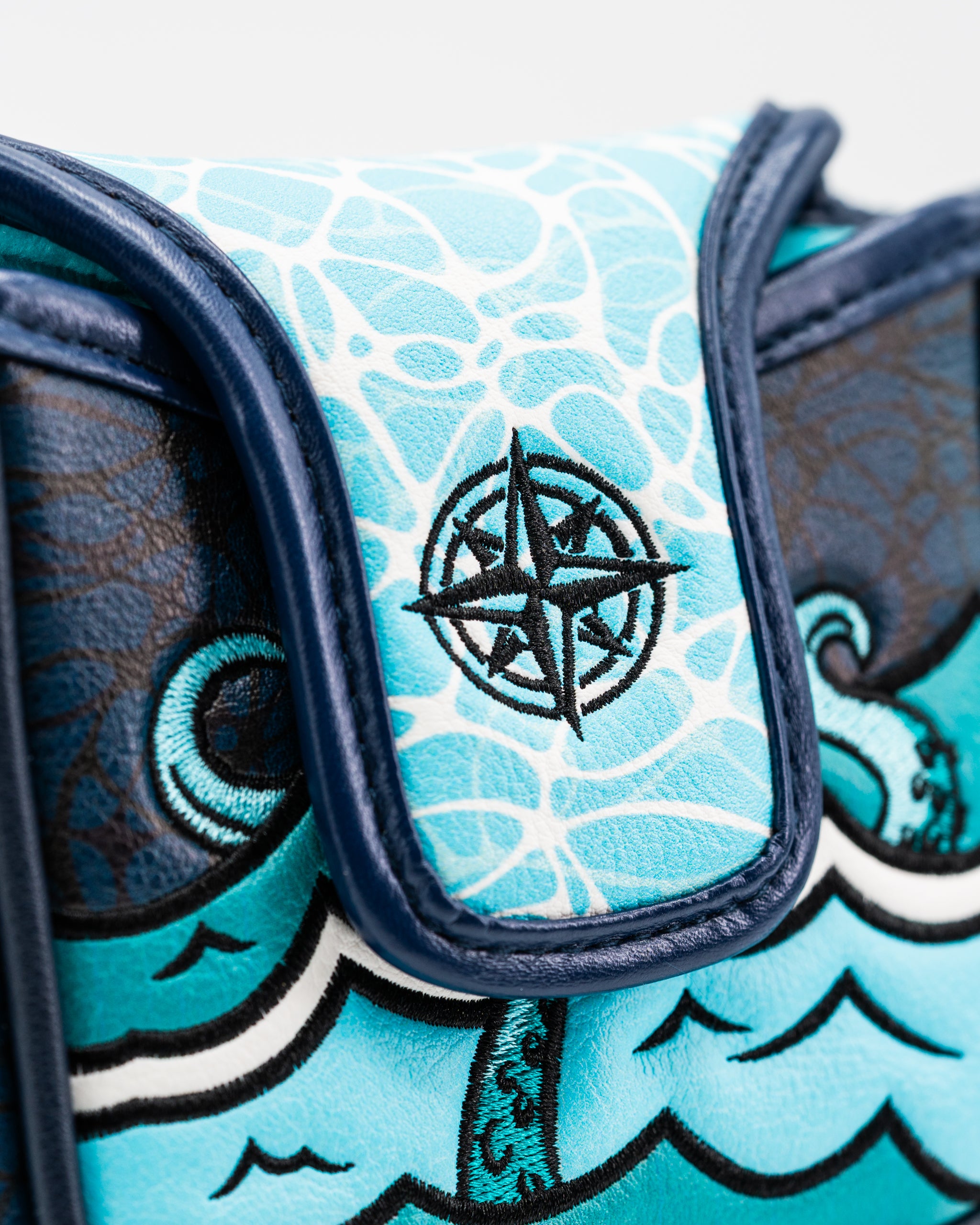 Kraken mallet putter cover featuring a vibrant ocean design and compass emblem, perfect for stylish golfers.