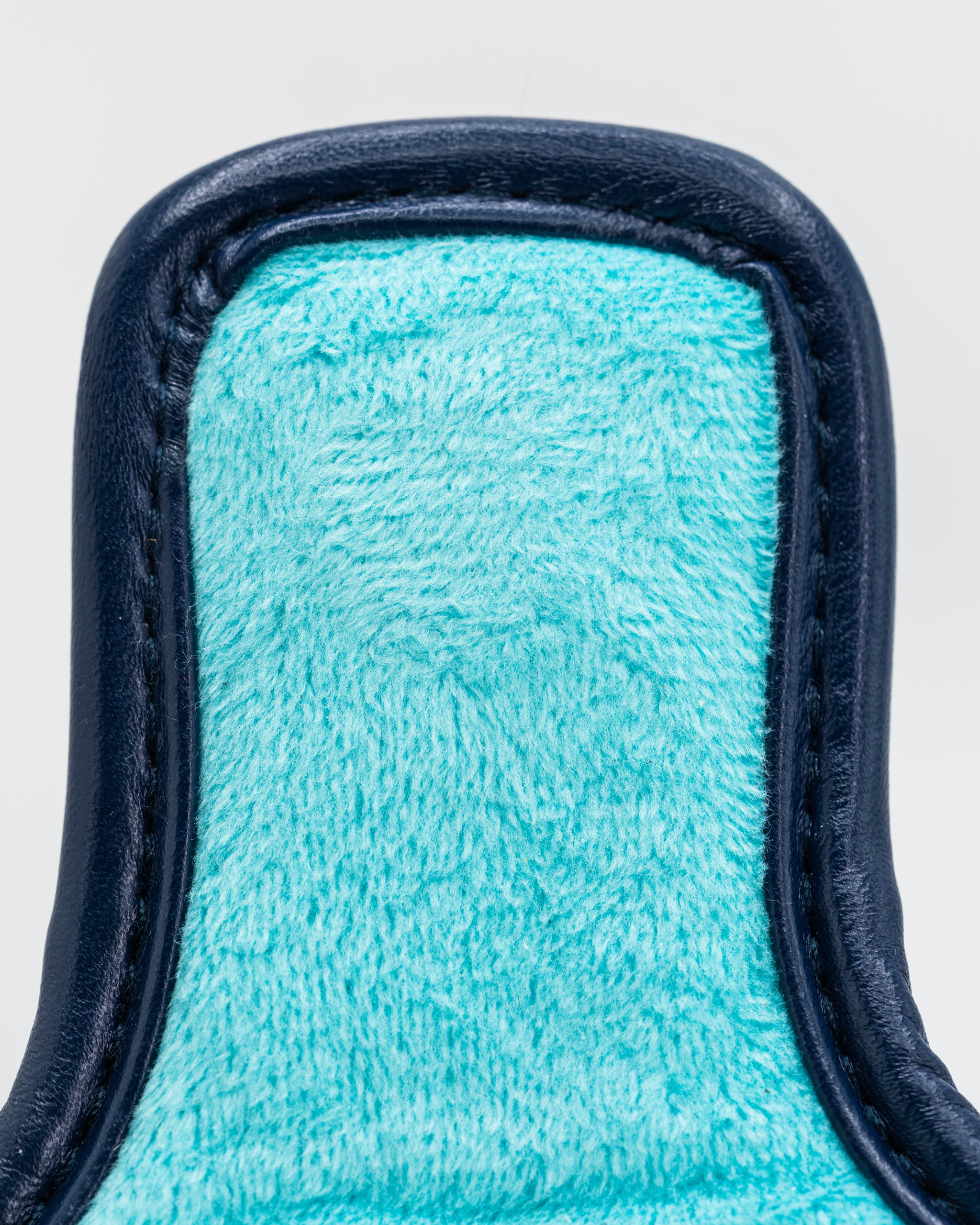 Close-up of the Kraken mallet putter cover featuring a soft turquoise interior and a sleek navy exterior.