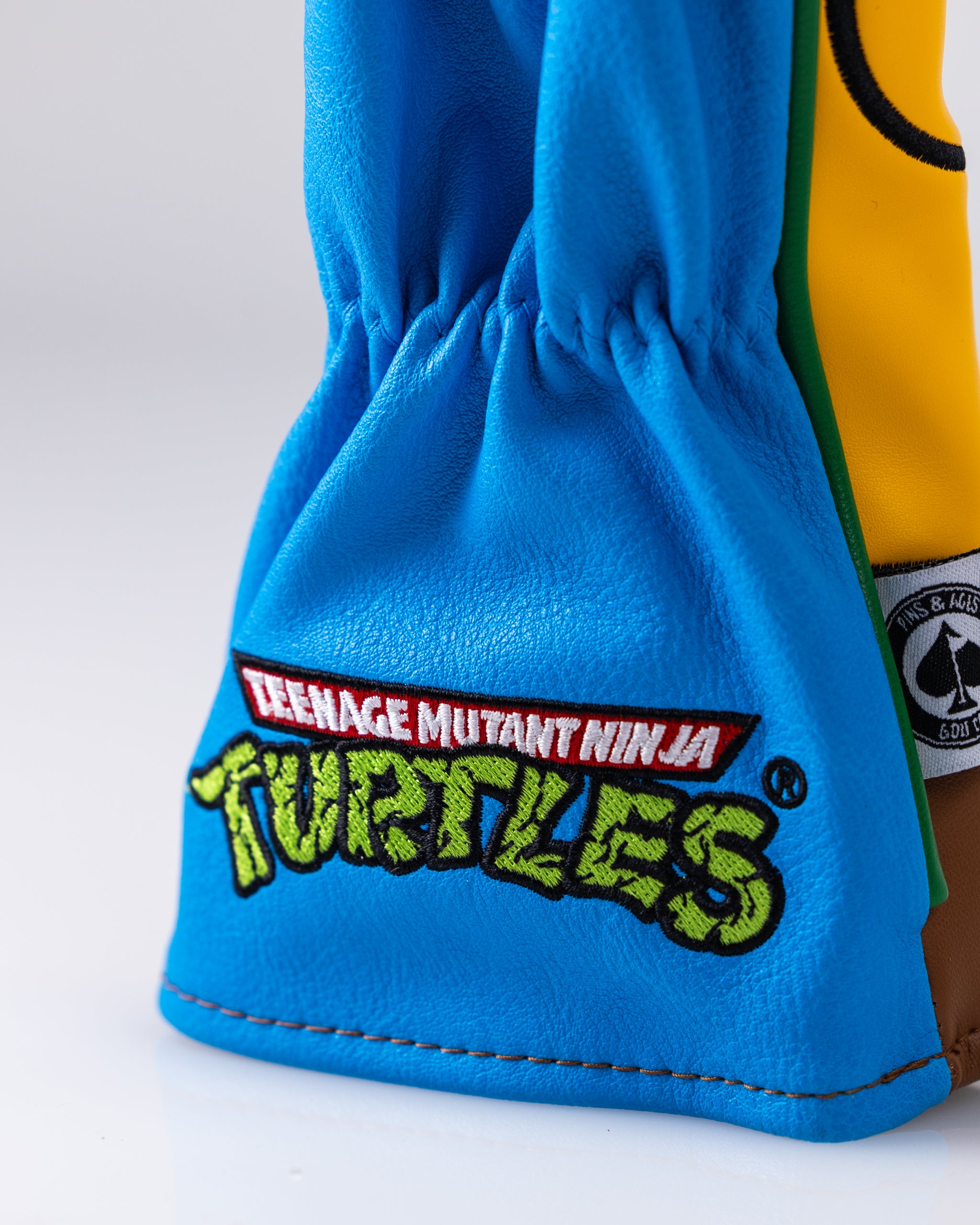 TMNT Leonardo hybrid golf club headcover featuring a vibrant blue and green design with the character's signature mask and weapons.