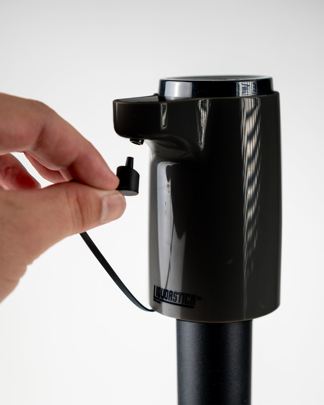 Black Liquorstick golf cart accessory with a sleek design and charging port, perfect for bold, unique golf style.