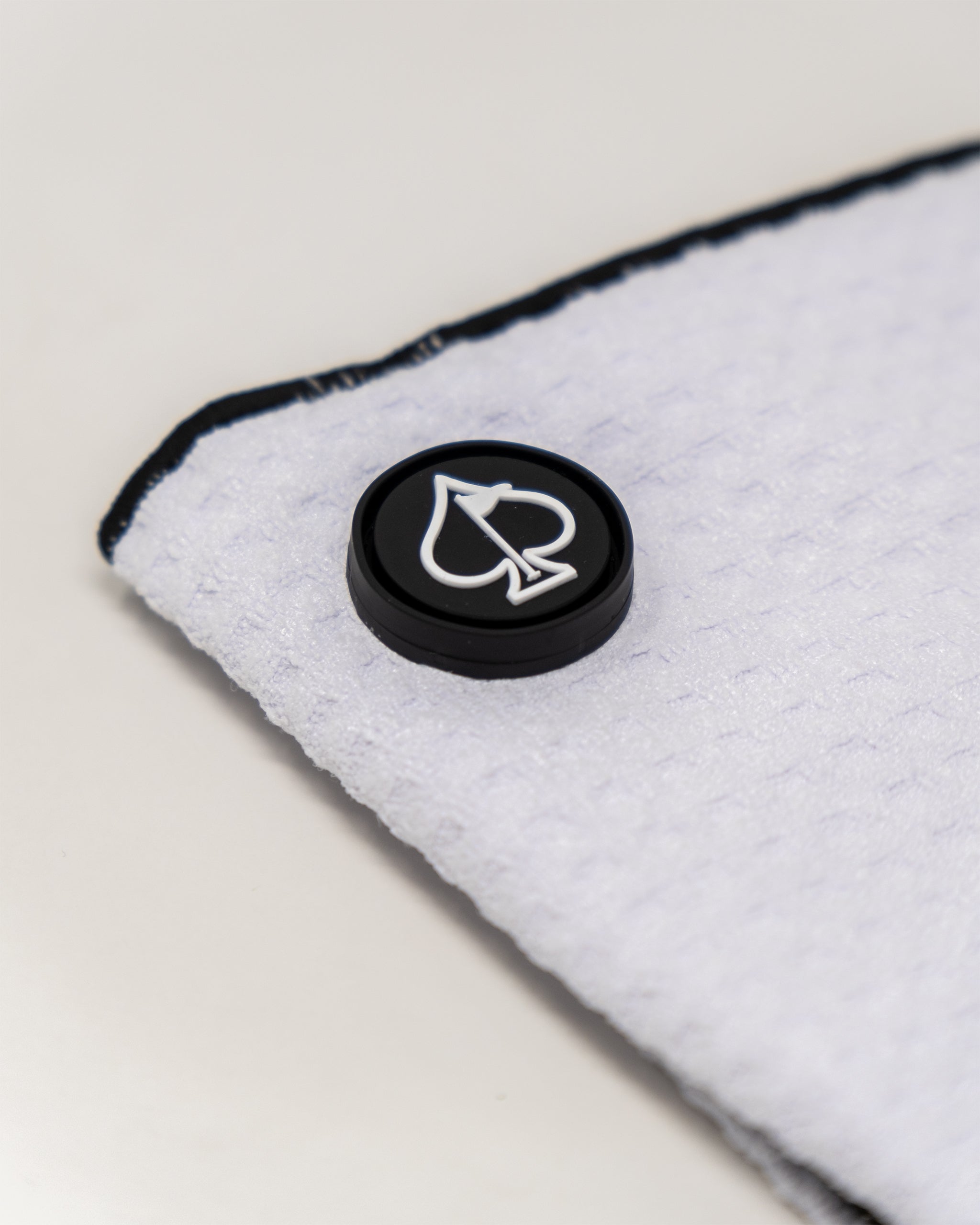 Magnetic white towel showcasing a sleek design with attachment magnets for easy hanging.