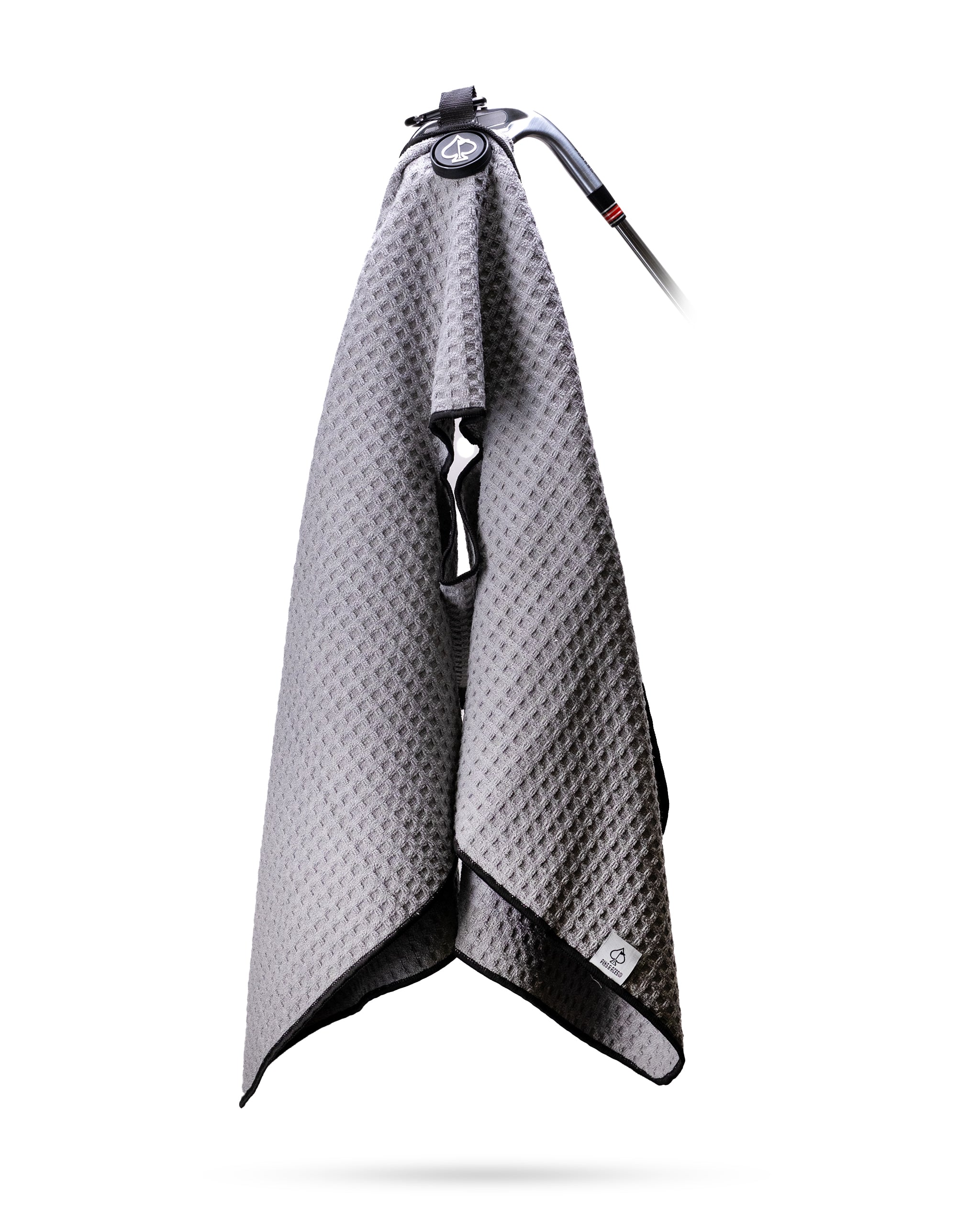 Gray magnetic towel hanging on a hook, showcasing its sleek design and magnetic feature.