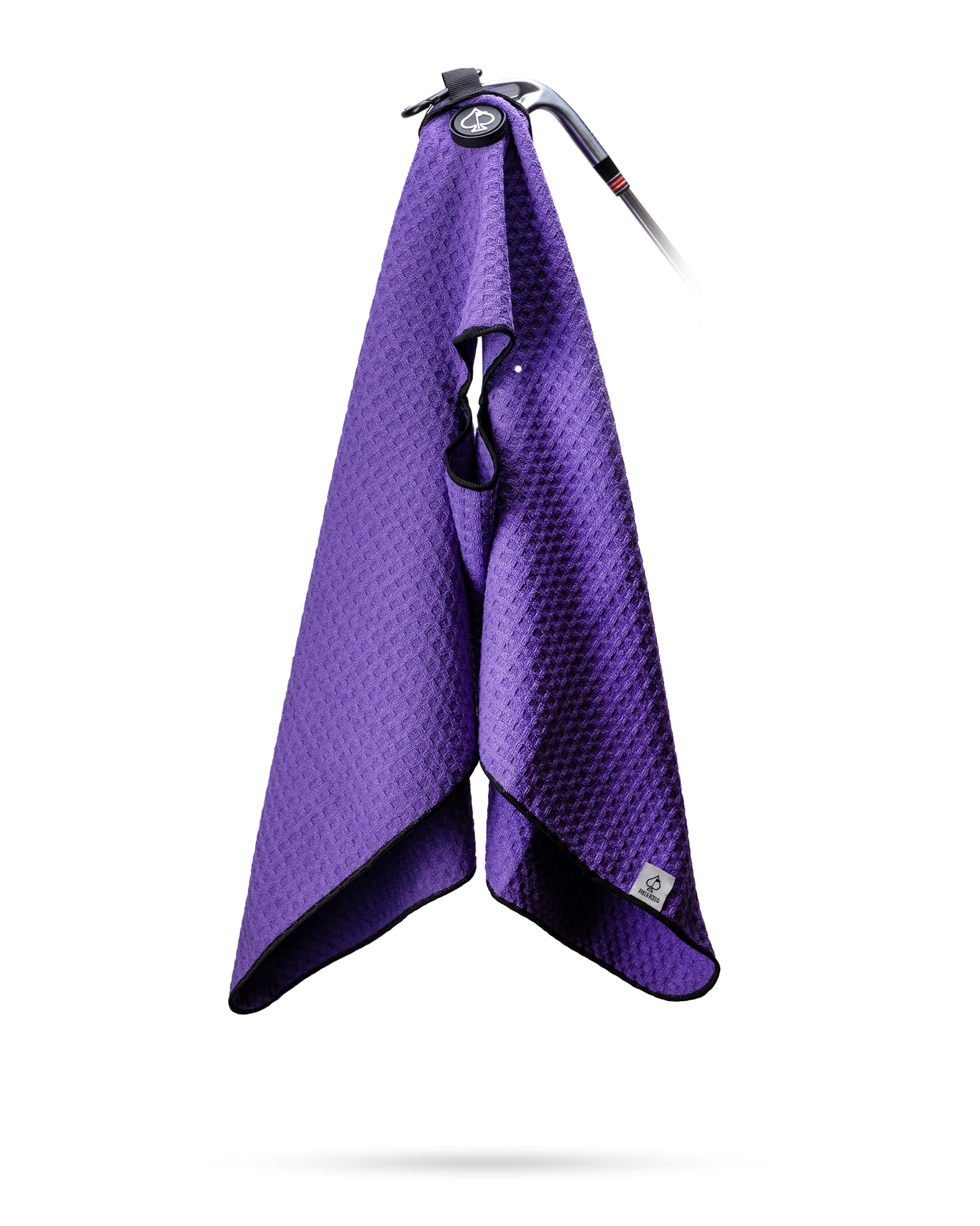 Purple textured golf towel hanging from a golf club, featuring a black border and a logo tag for bold, standout golf acces...