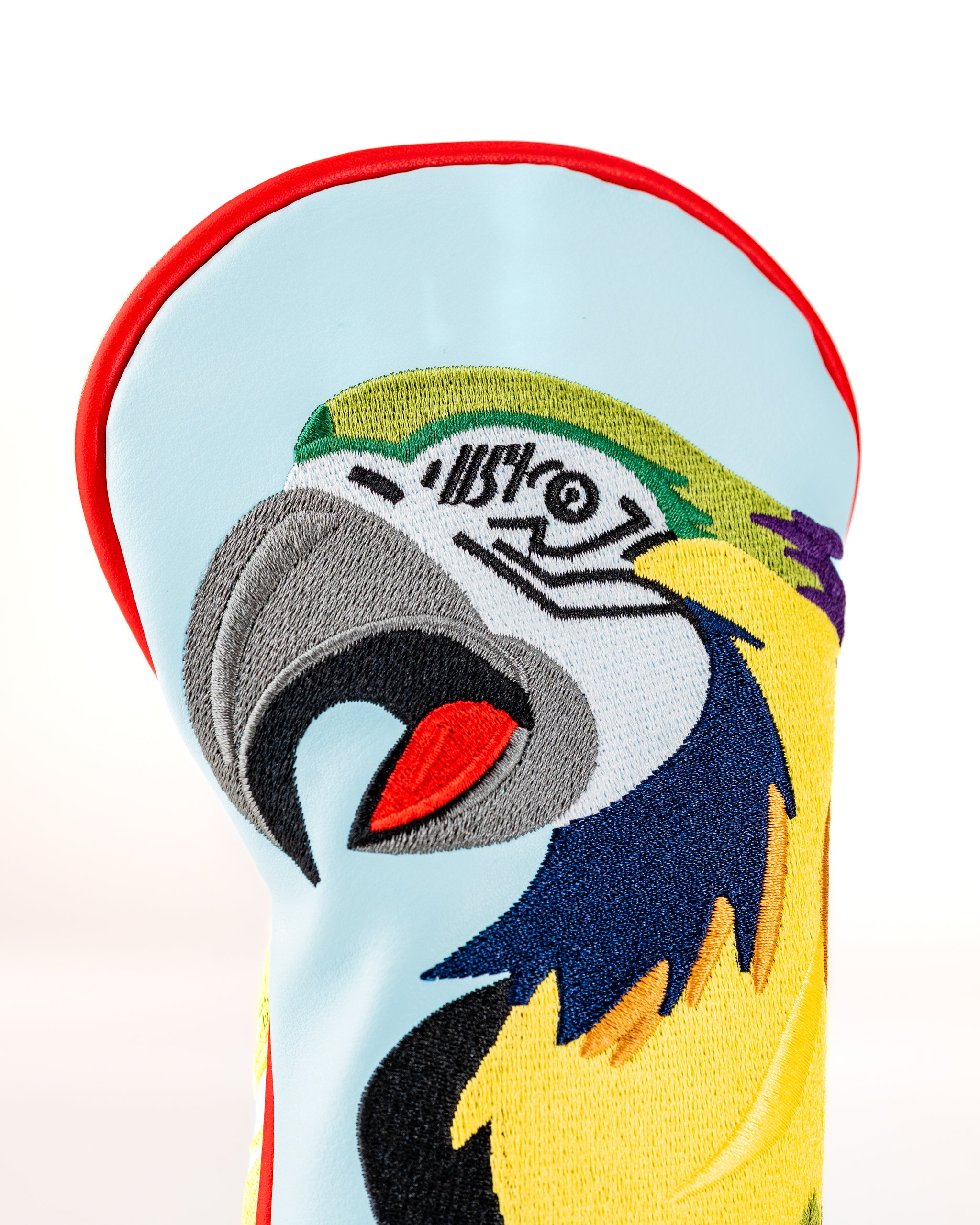 Colorful Margaritaville x Pins & Aces headcover featuring a vibrant parrot design, perfect for adding flair to your golf game.