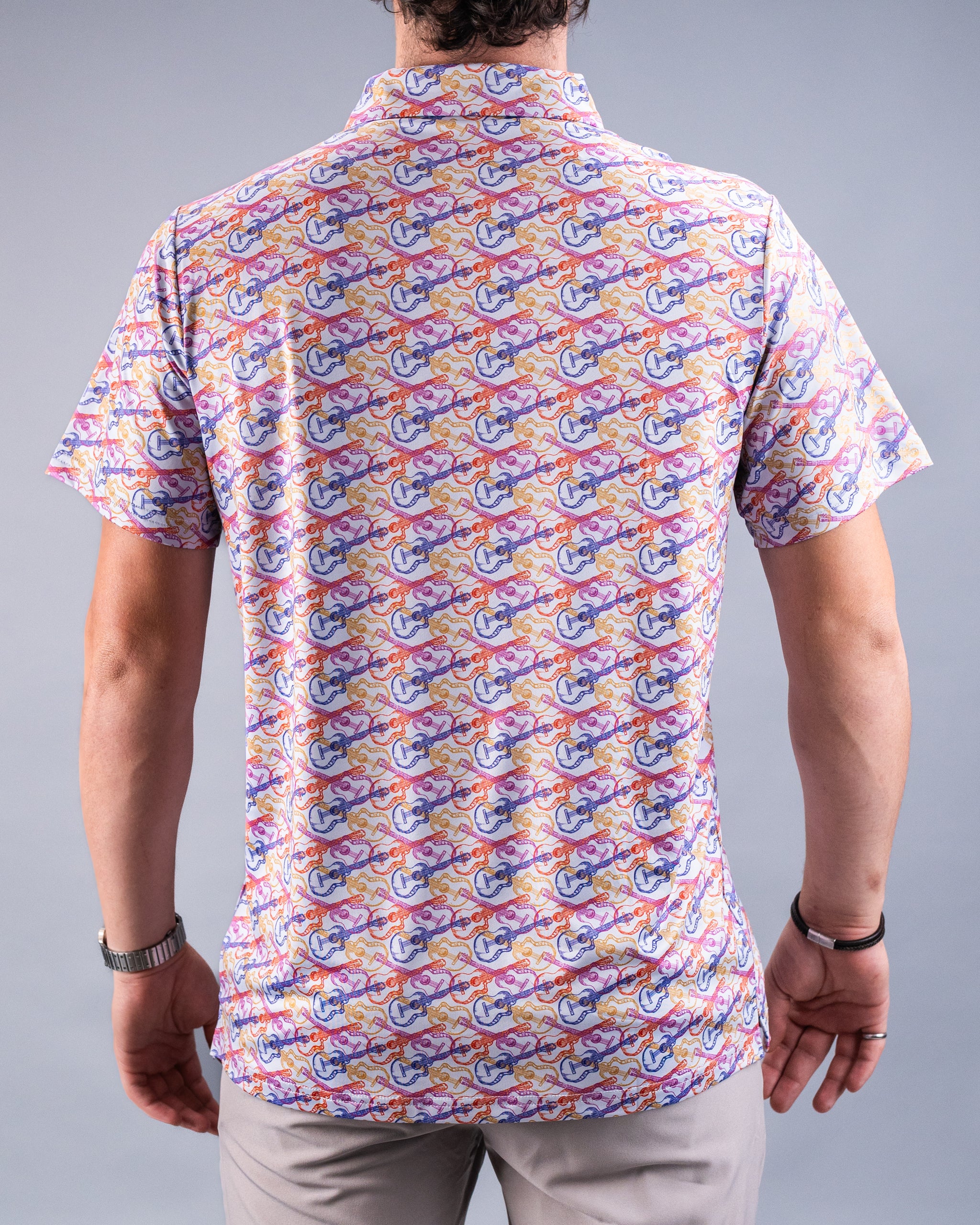 Back view of a man wearing a colorful, patterned golf shirt with blue, purple, orange, and pink abstract designs, perfect ...