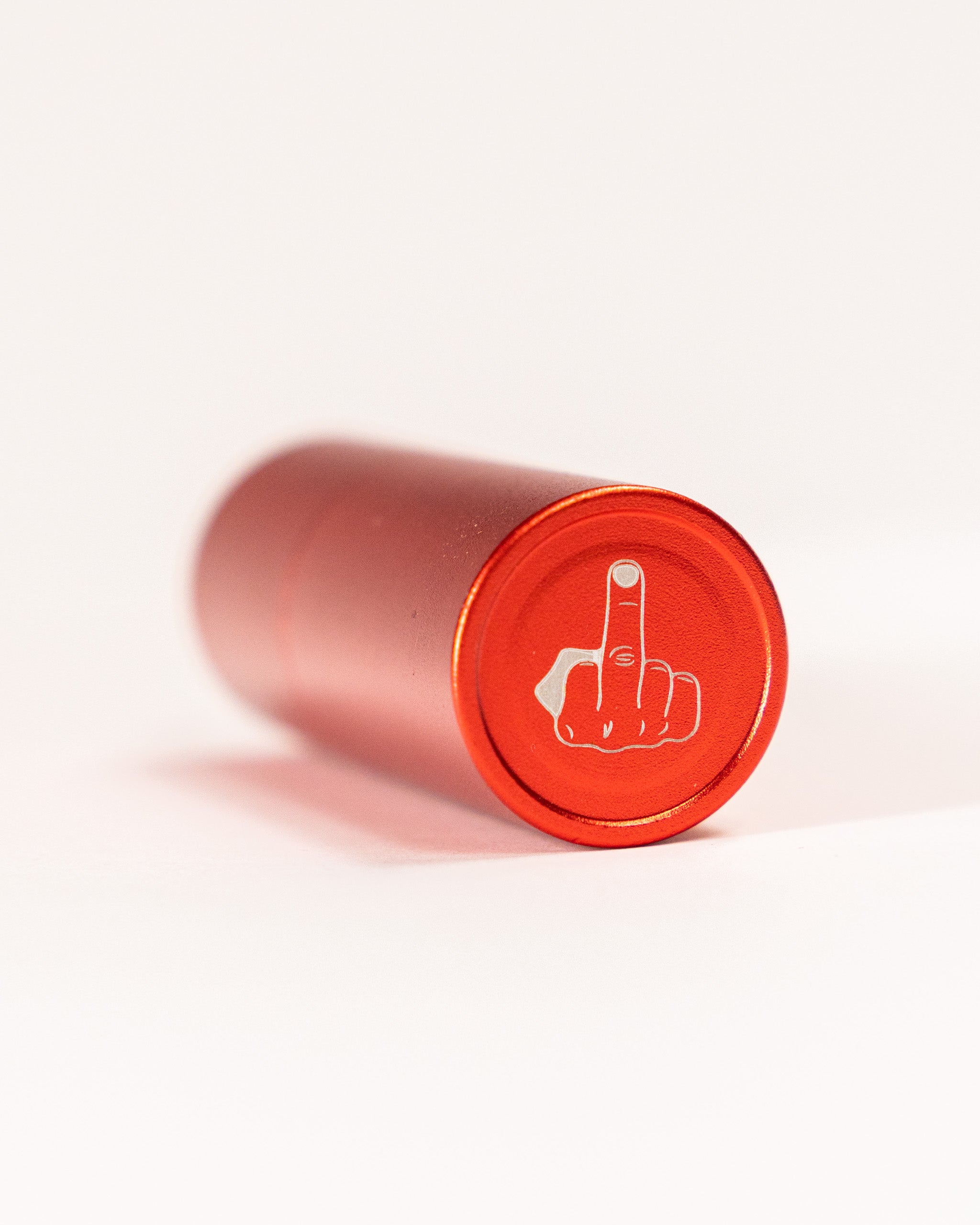 Red cylindrical stamp with a white outline of a hand showing the middle finger gesture on the bottom.