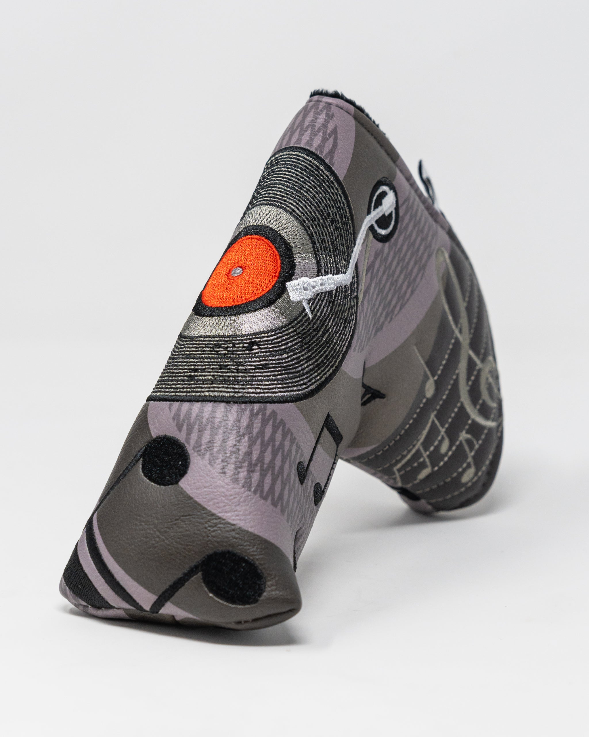 Music City Blade Putter Cover featuring a vibrant design with musical motifs, perfect for golf enthusiasts.