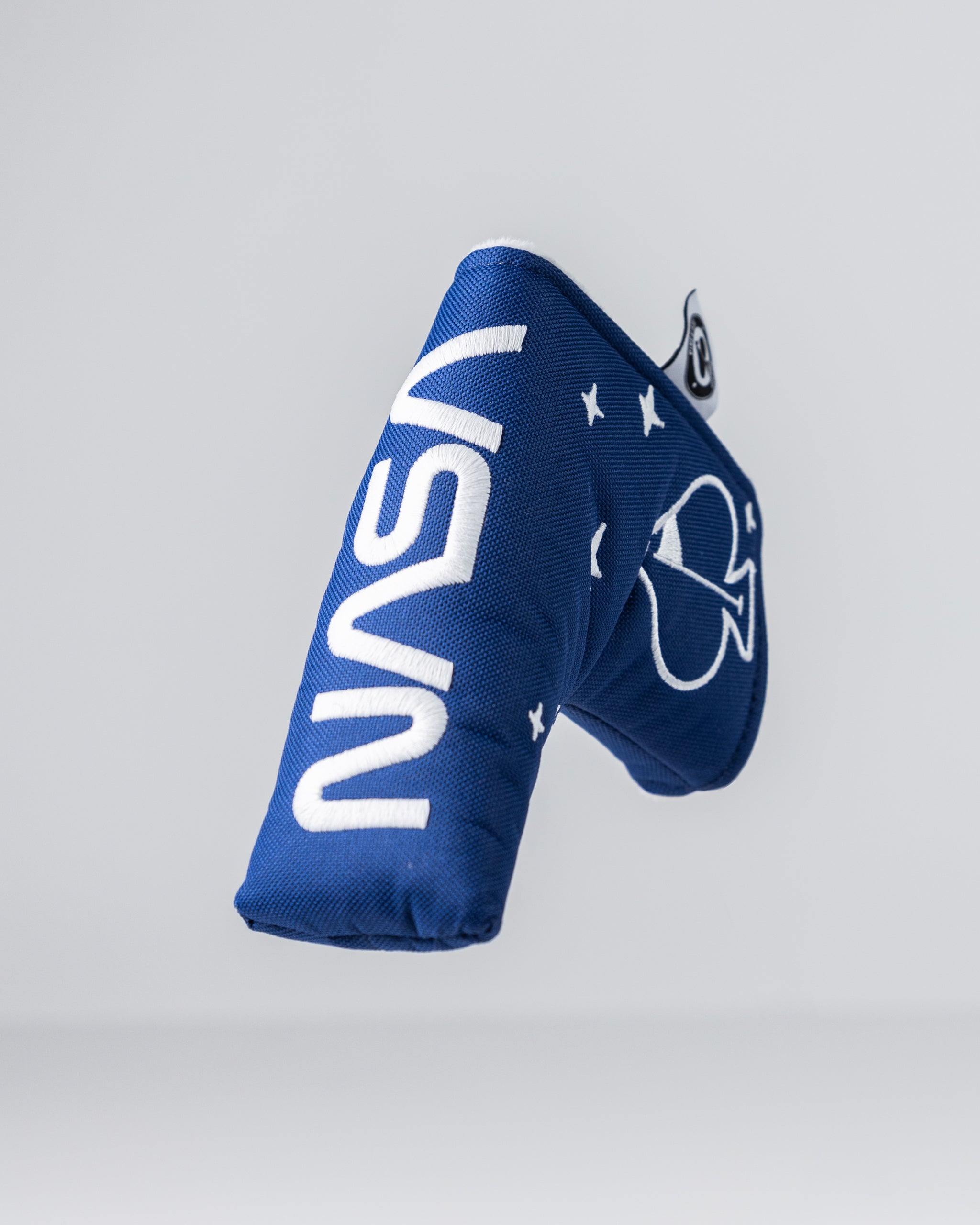 Blue golf club headcover with bold white "MAVS" text and a Dallas Mavericks logo, featuring stars and team colors.