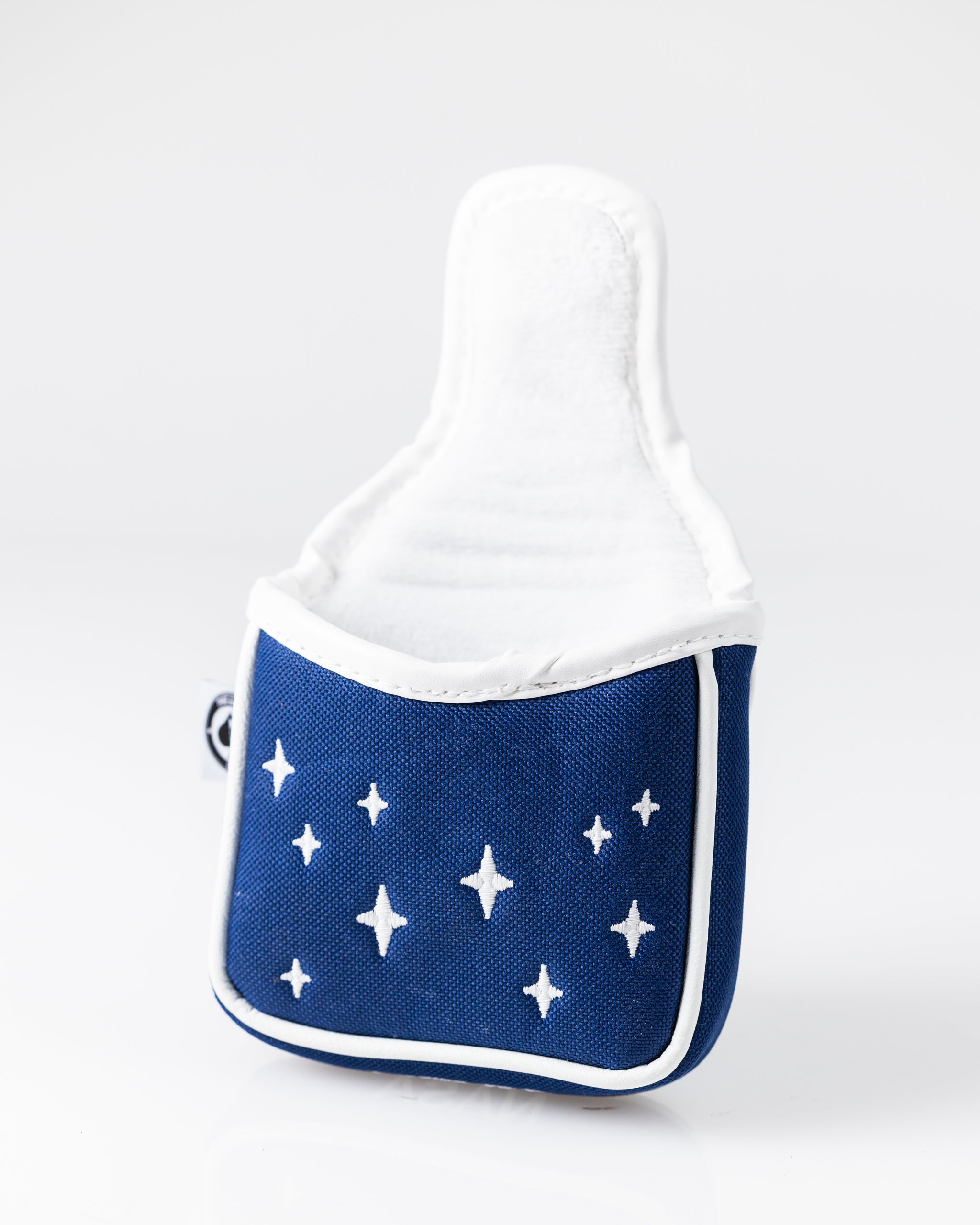 Blue golf headcover with white starburst pattern, white trim, and soft interior lining for standout style on the course.