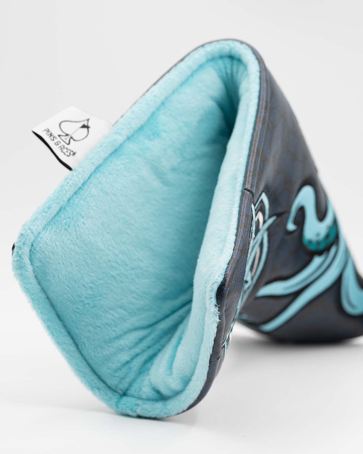 Kraken blade putter cover featuring a sleek design with a vibrant blue interior and detailed graphic elements.