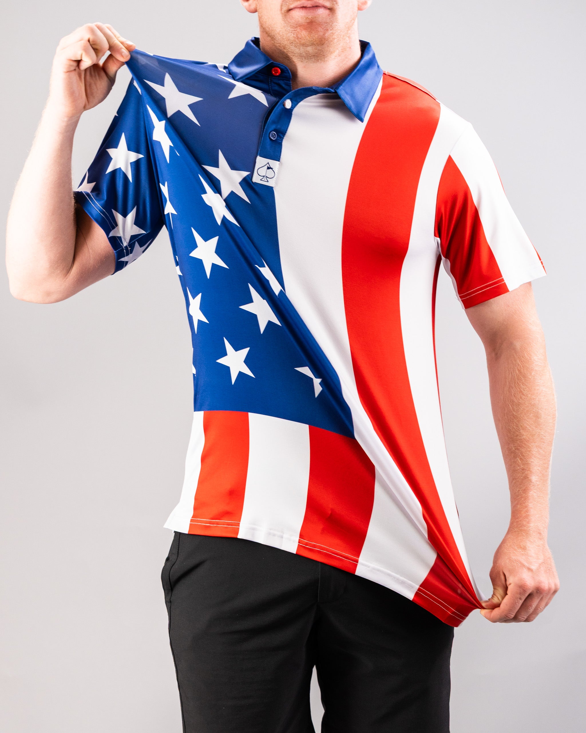 A person wearing a patriotic golf shirt featuring a design inspired by the American flag, with stars and stripes in red, white, and blue.