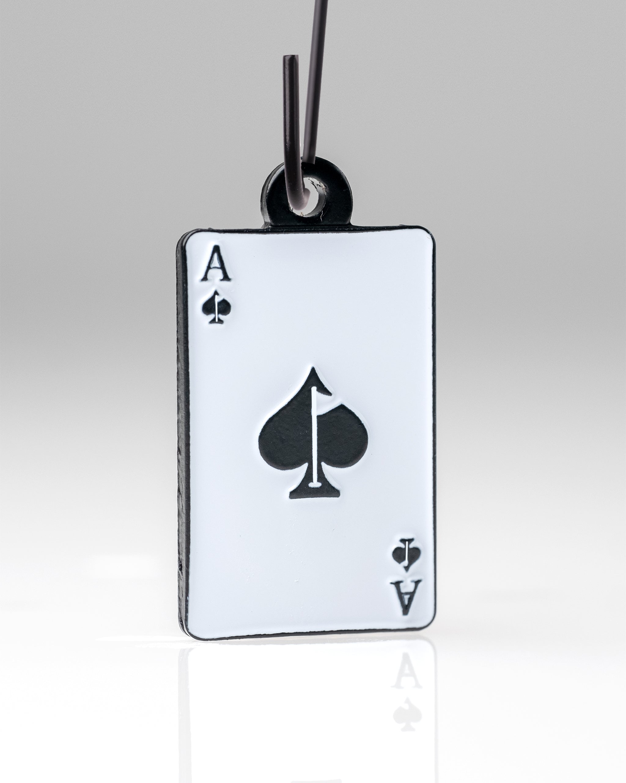 Ace of Spades playing card ornament hanging by a loop, featuring prominent spade suit symbol and letter 'A' in black on a white background.