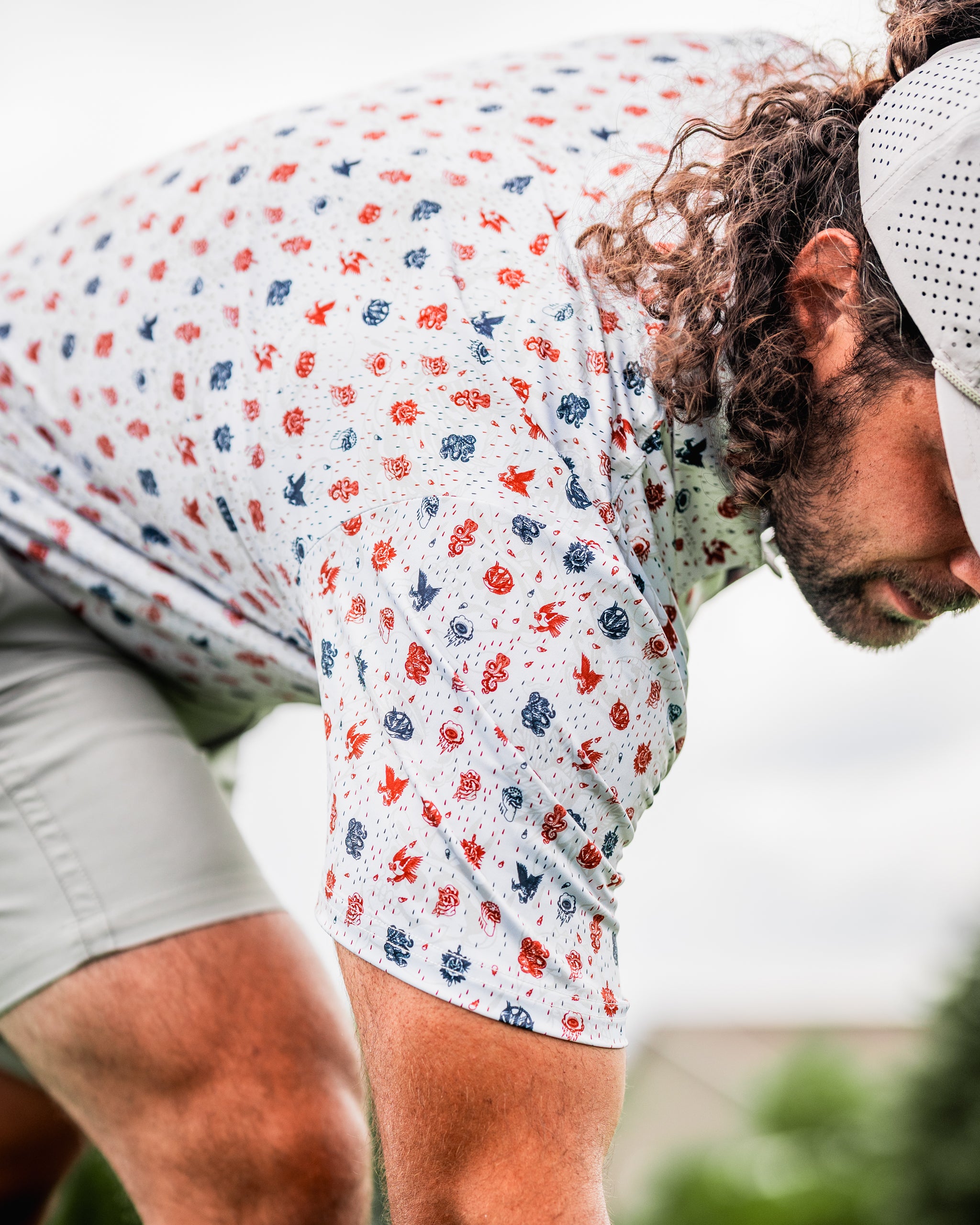 Bold golf shirt featuring an American traditional pattern with red and blue designs, perfect for stylish golfers.