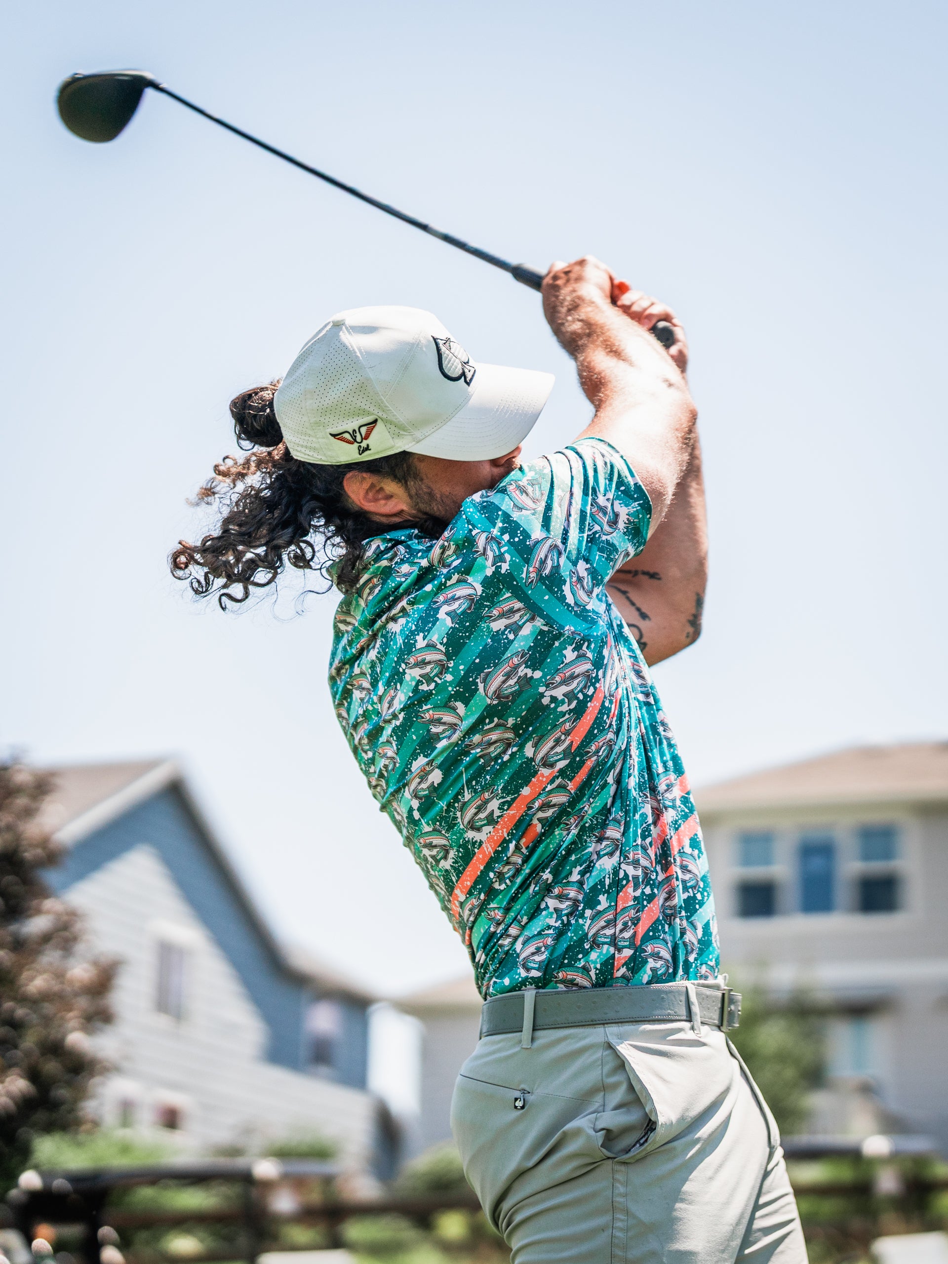 Bold golf shirt featuring a vibrant trout splatter design, perfect for making a statement on the course.
