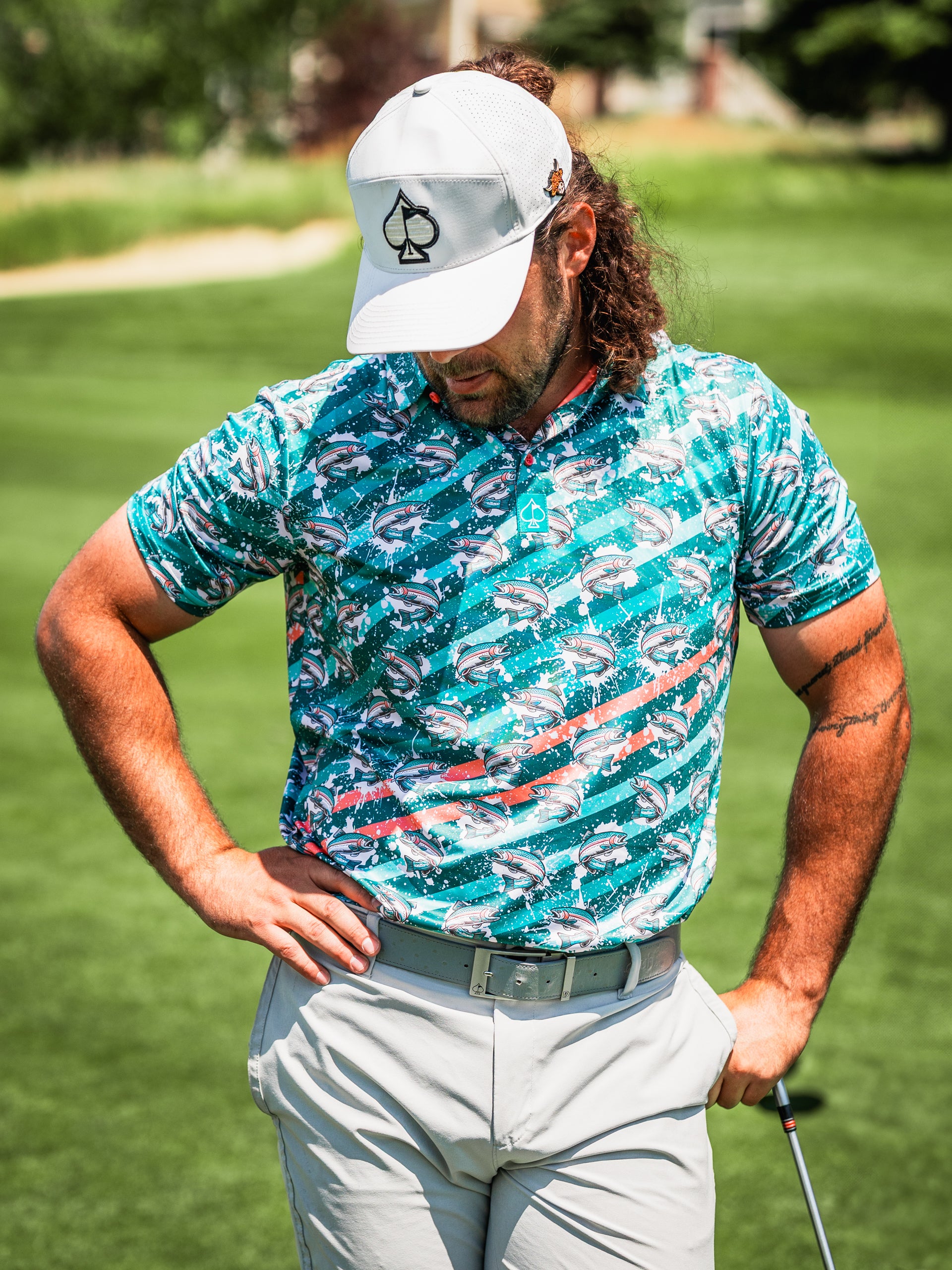 Bold golf shirt featuring a trout splatter design, perfect for golfers wanting to make a statement on the course.