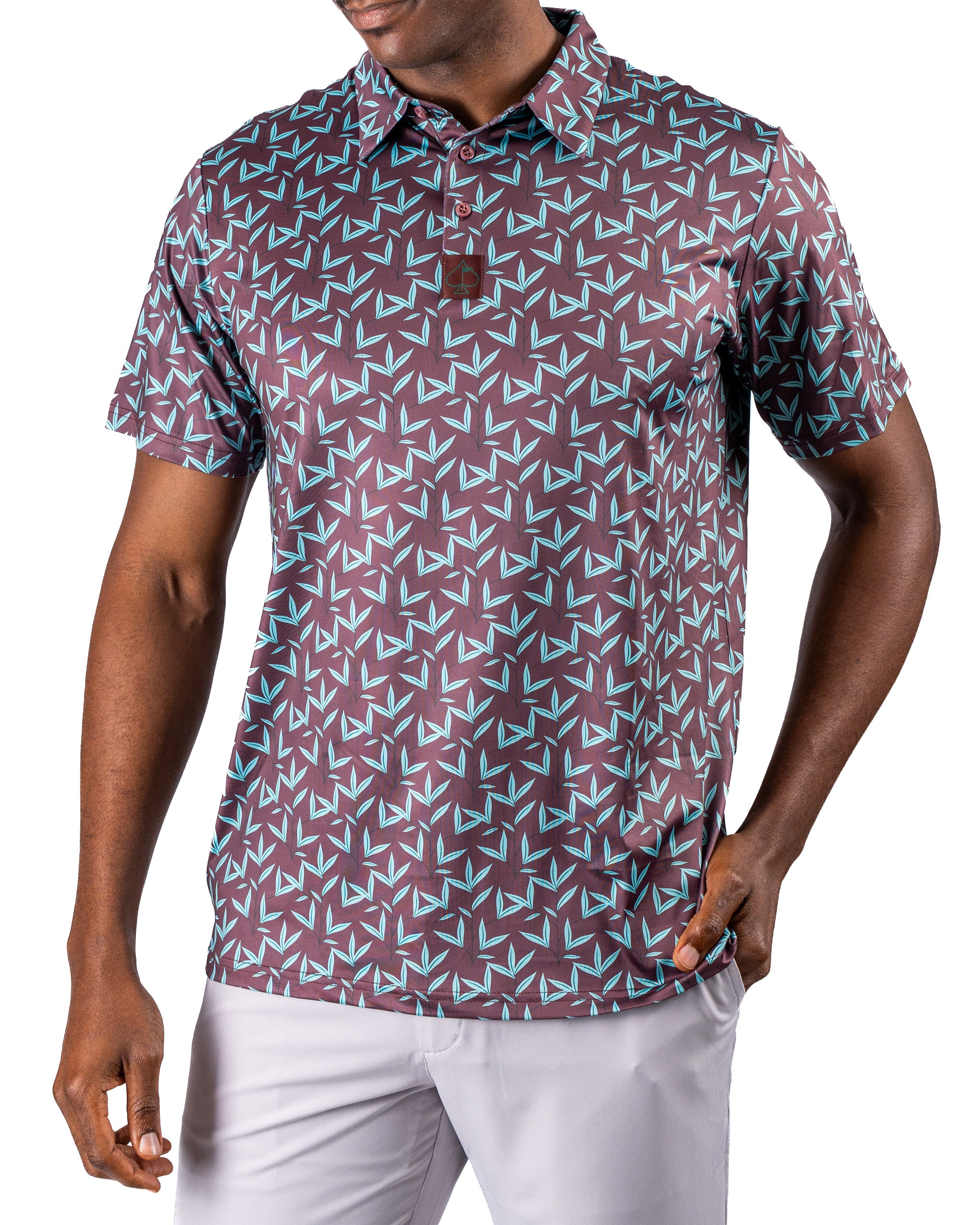 Men's Cocoa Verde golf polo featuring a bold geometric pattern in maroon and teal, designed for stylish performance on the course.