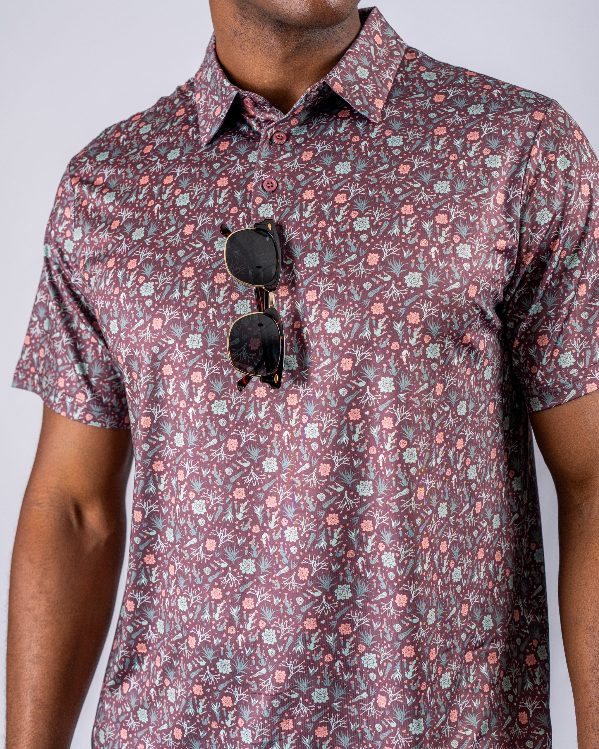 Men's Desert Sage golf shirt featuring a vibrant floral pattern, perfect for stylish performance on the course.