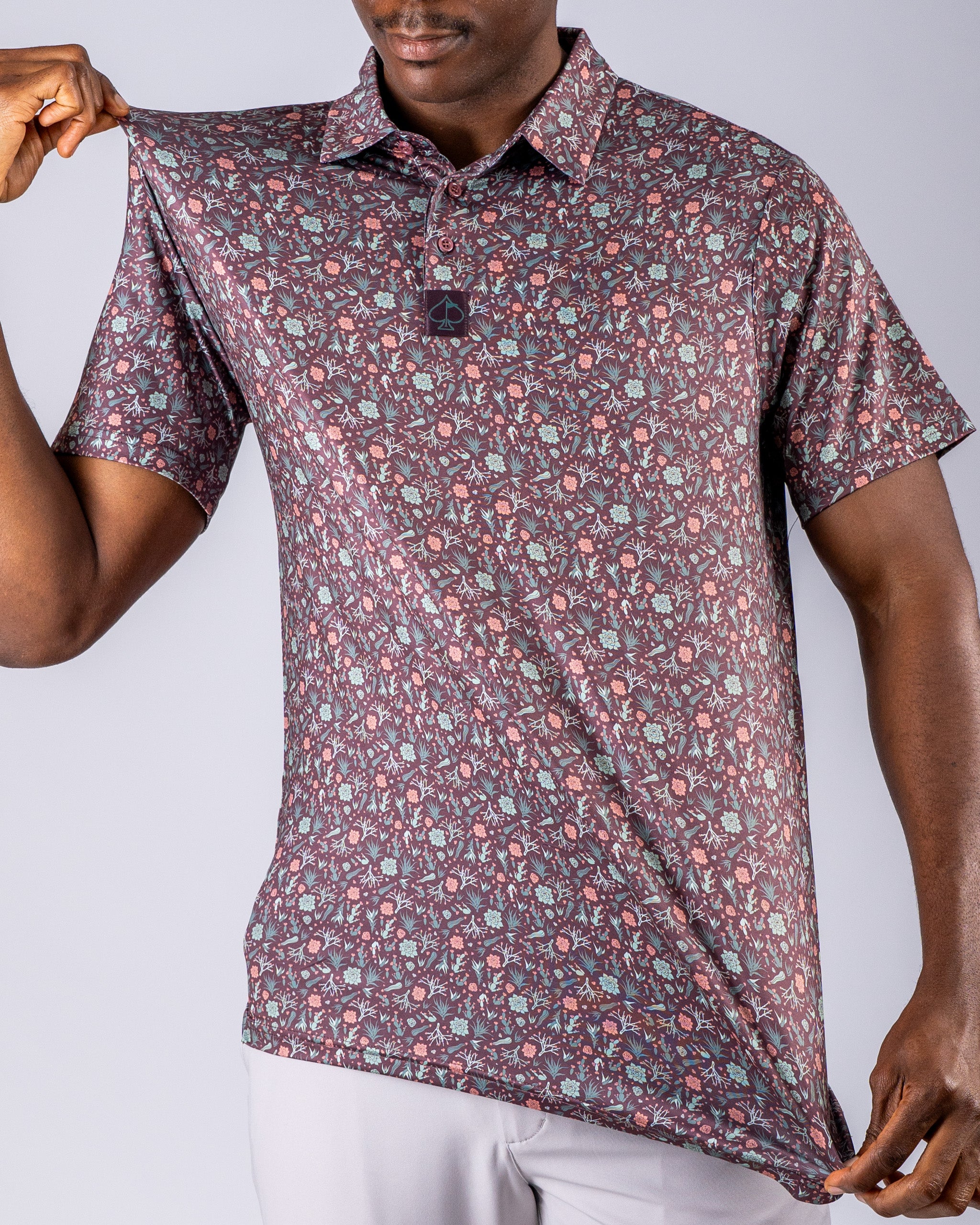 Men's Desert Sage golf polo featuring a vibrant floral pattern, designed for stylish performance on the course.