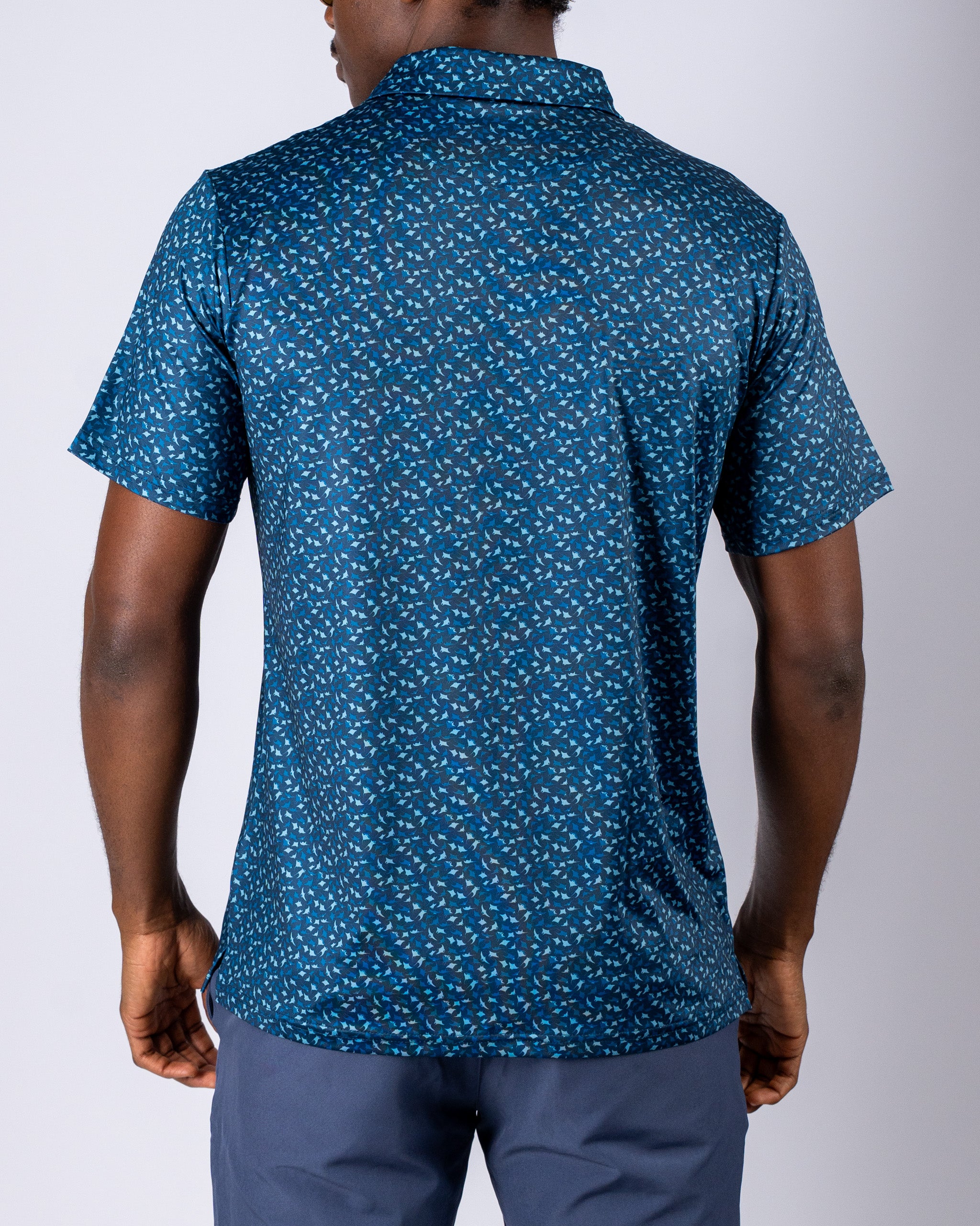 Men's Manta Ray golf shirt featuring a vibrant blue pattern, designed for comfort and style on the course.