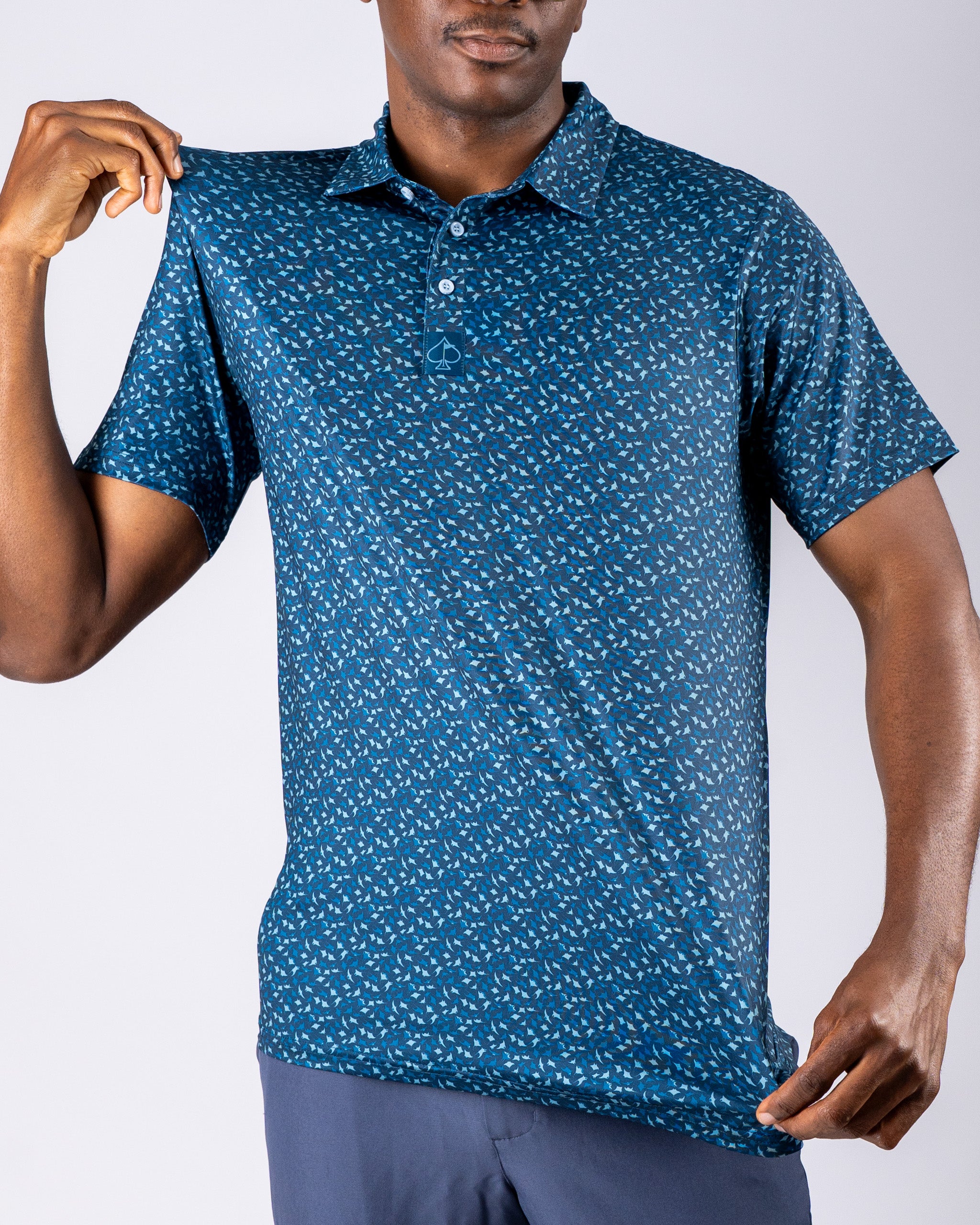 Men's Manta Ray golf polo featuring a vibrant blue pattern, designed for style and comfort on the course.