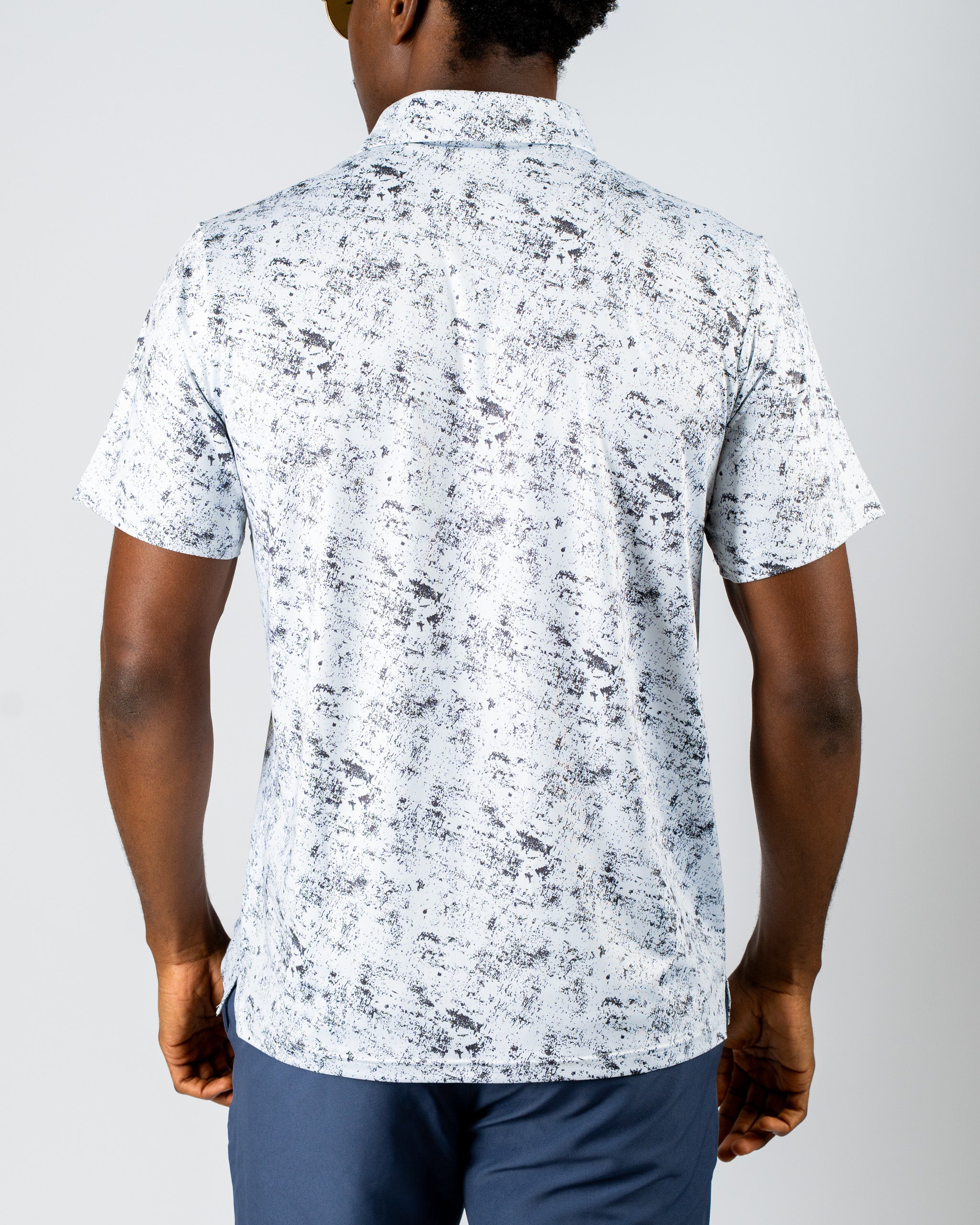 Men's short-sleeve golf shirt in a white and gray abstract pattern, featuring a relaxed fit and modern design.