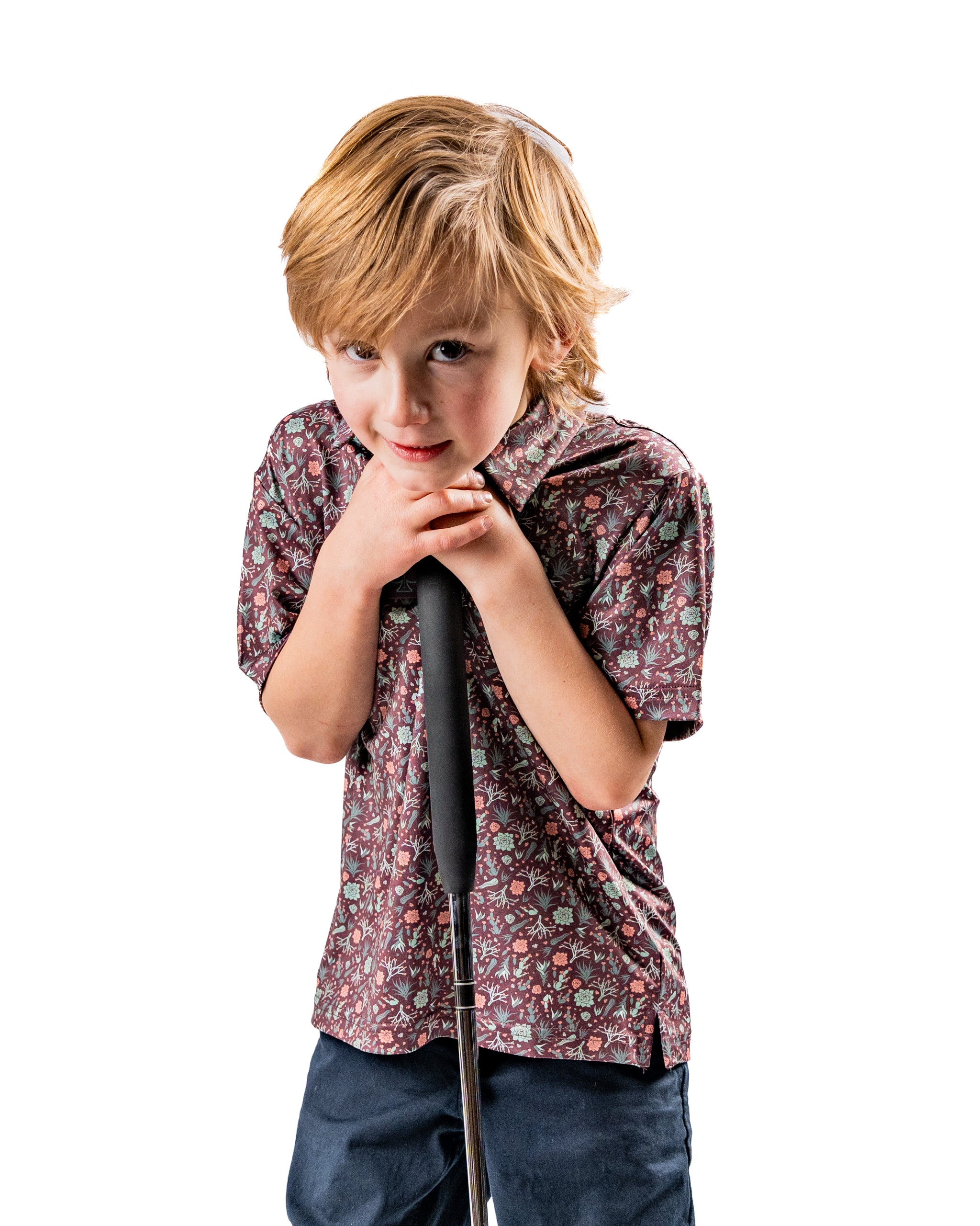 Youth Desert Sage shirt features a playful floral pattern, perfect for young golfers looking to stand out on the course.