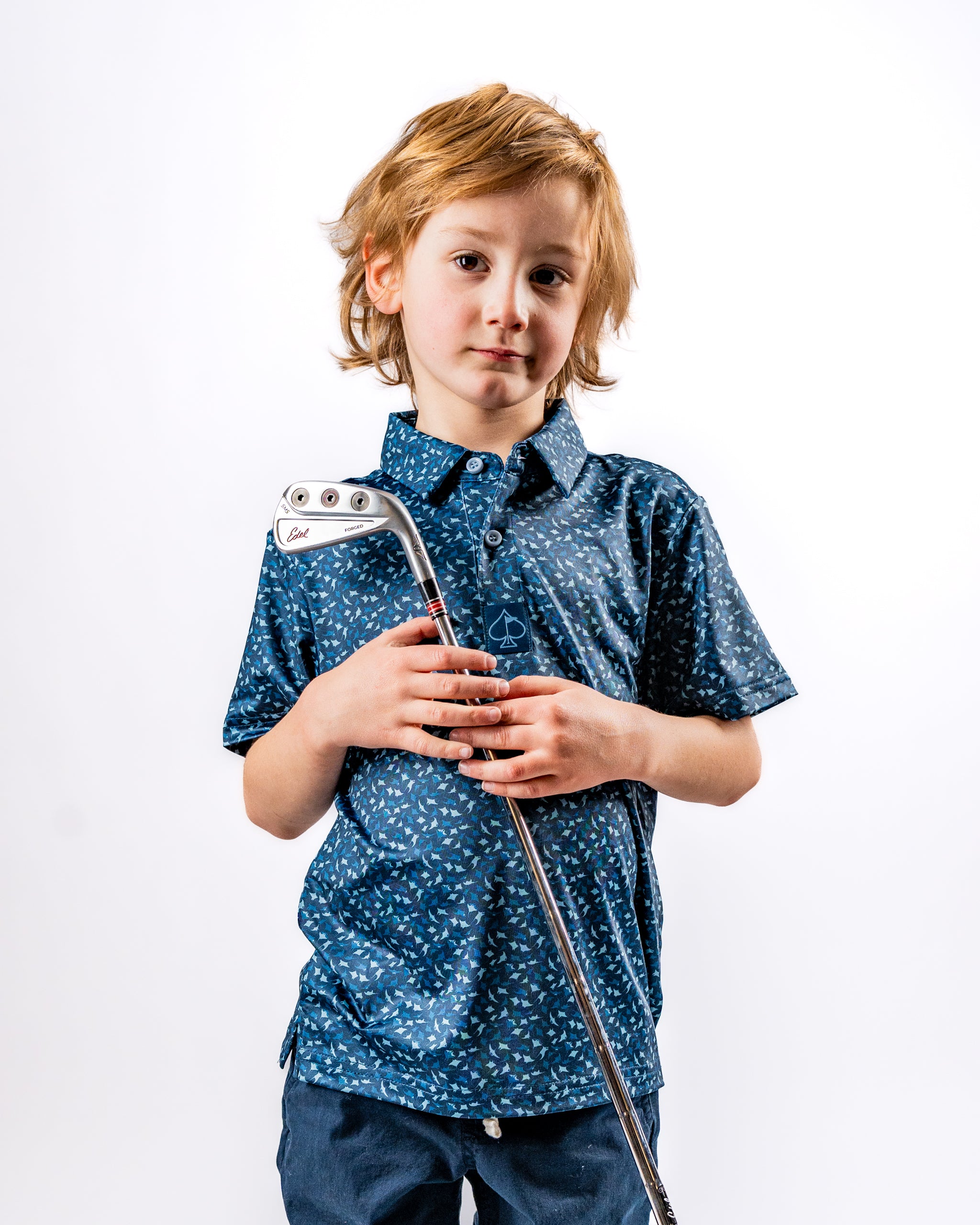 Youth Manta Ray golf shirt featuring a playful blue pattern, perfect for young golfers looking to stand out on the course.