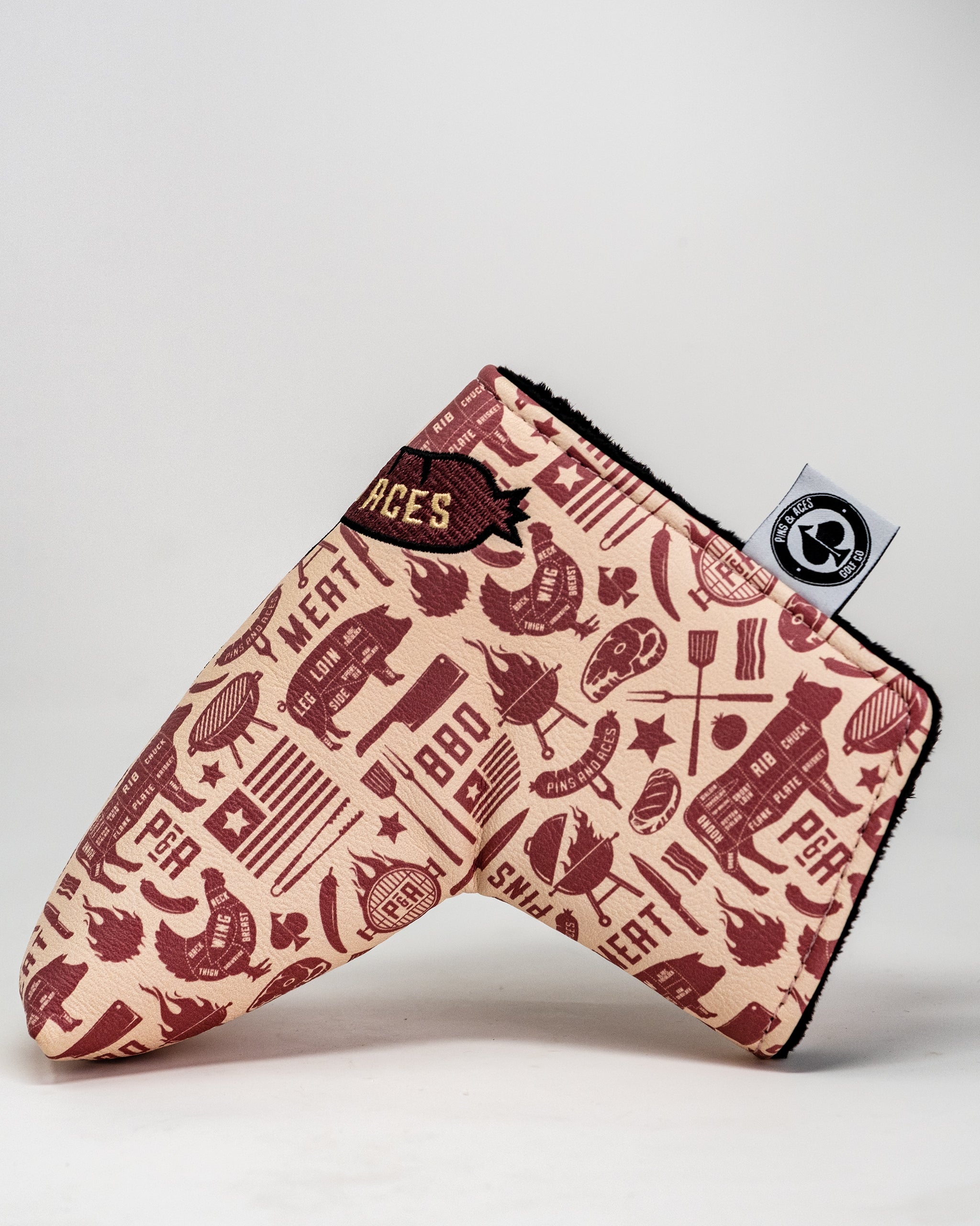 BBQ Links Blade Putter Cover featuring a vibrant BBQ design with grill graphics and a soft, padded exterior for protection.