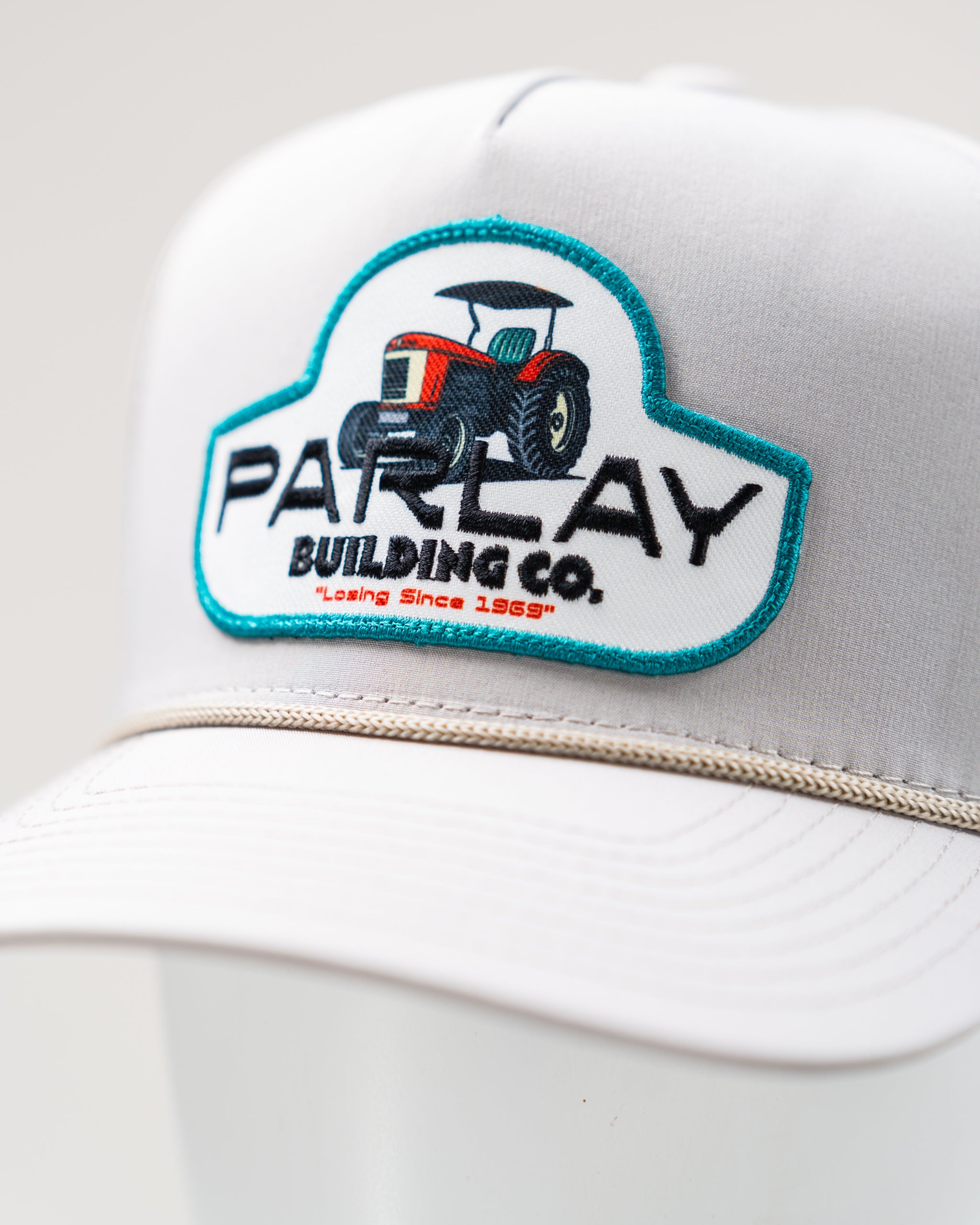 Perforated rope hat in bone color by Parlay Building Co., featuring a stylish design and adjustable strap.