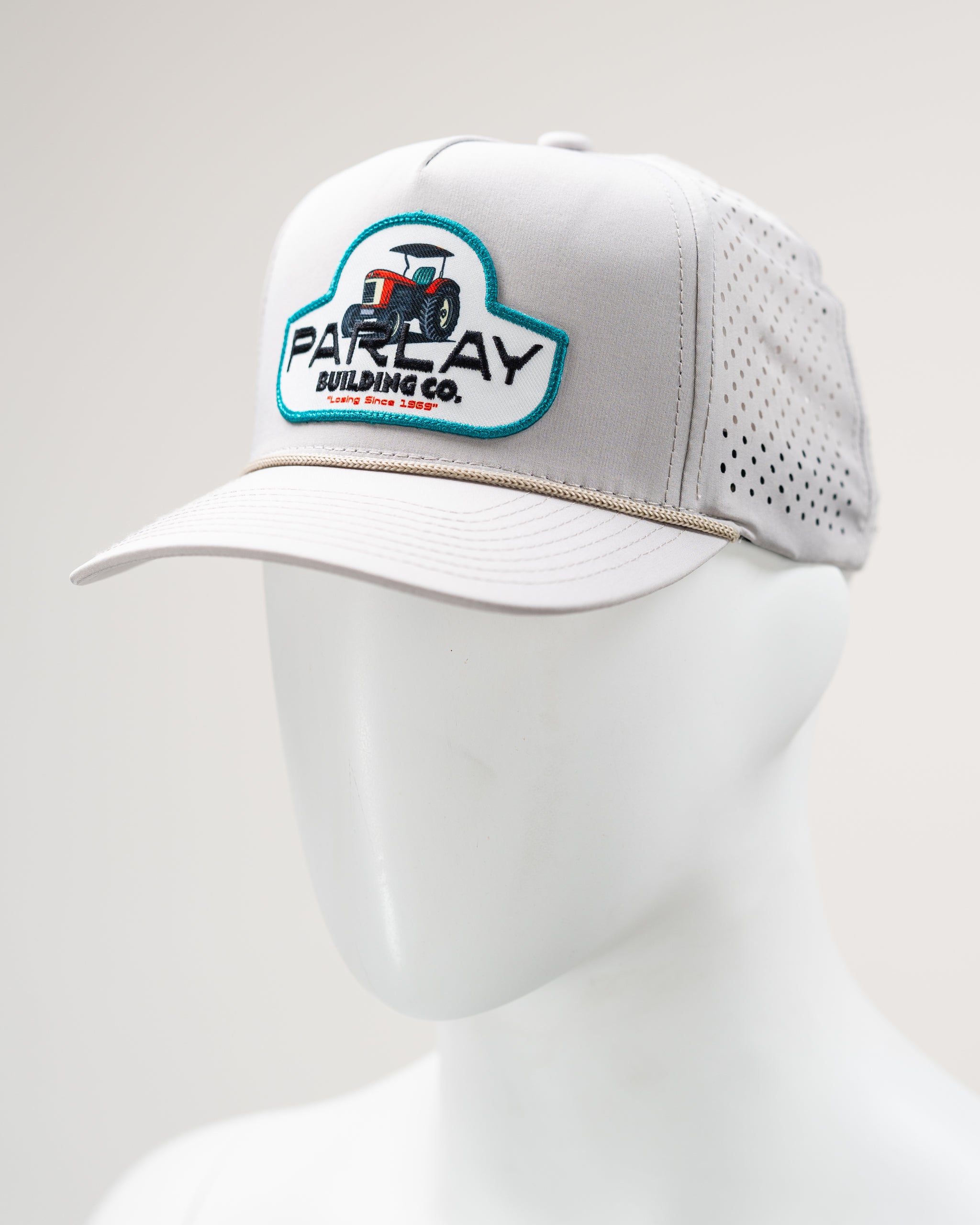 Perforated rope hat in bone color by Parlay Building Co. featuring a stylish design and adjustable strap.