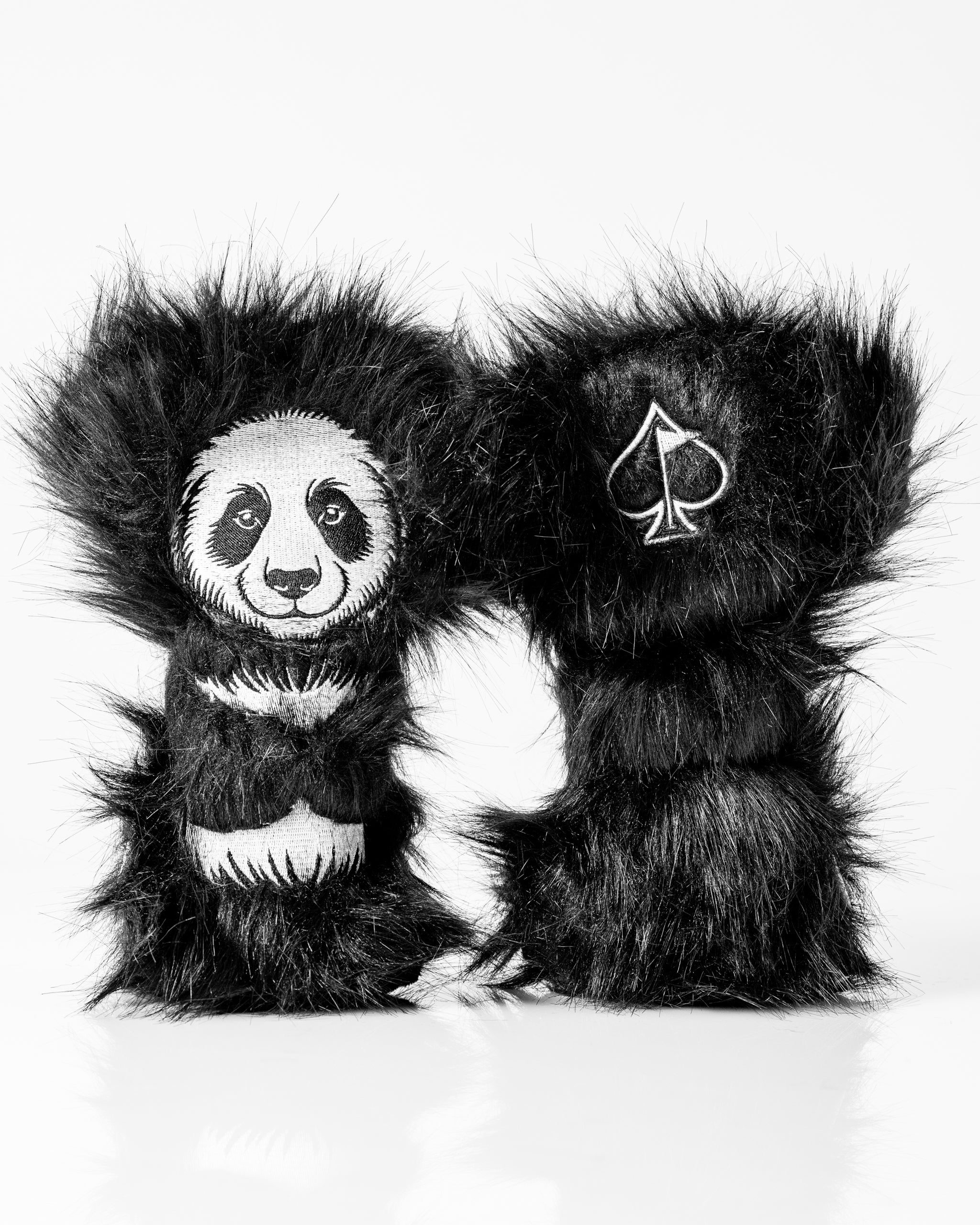 Panda hybrid golf headcover featuring a fluffy black design with a panda graphic and spade logo for stylish protection.
