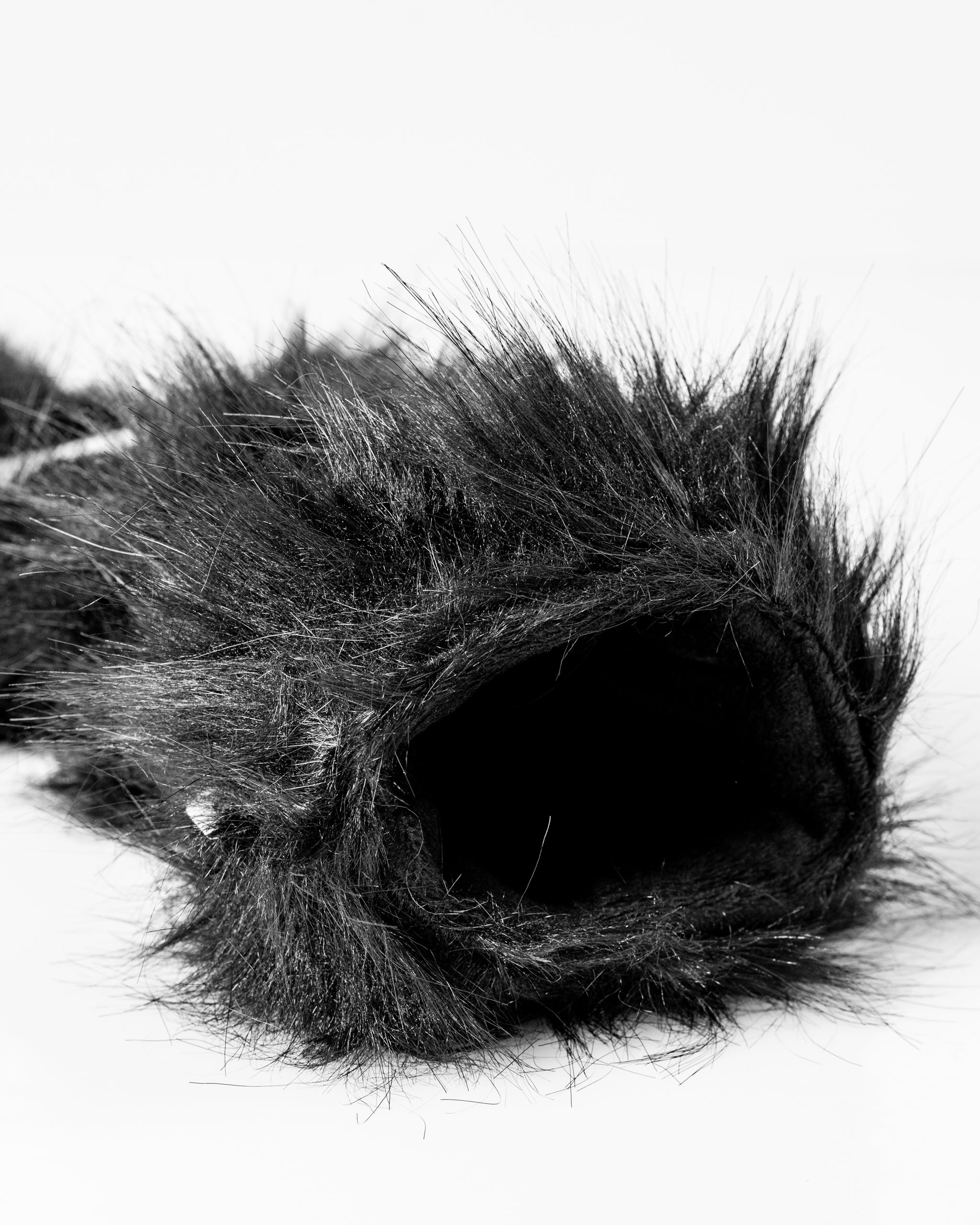 Soft black panda hybrid golf headcover with realistic fur texture, designed to protect and style your clubs on the course.