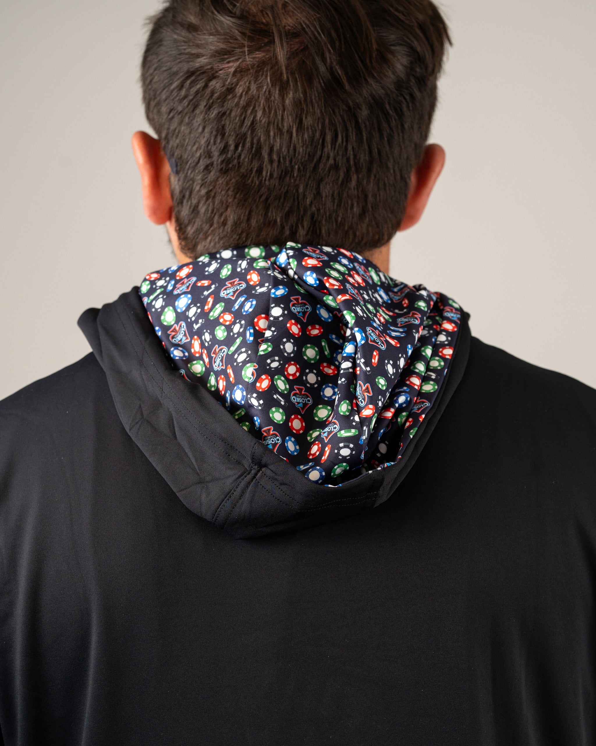 Men's performance golf hoodie featuring a colorful patterned inner hood, designed for comfort and style on the course.