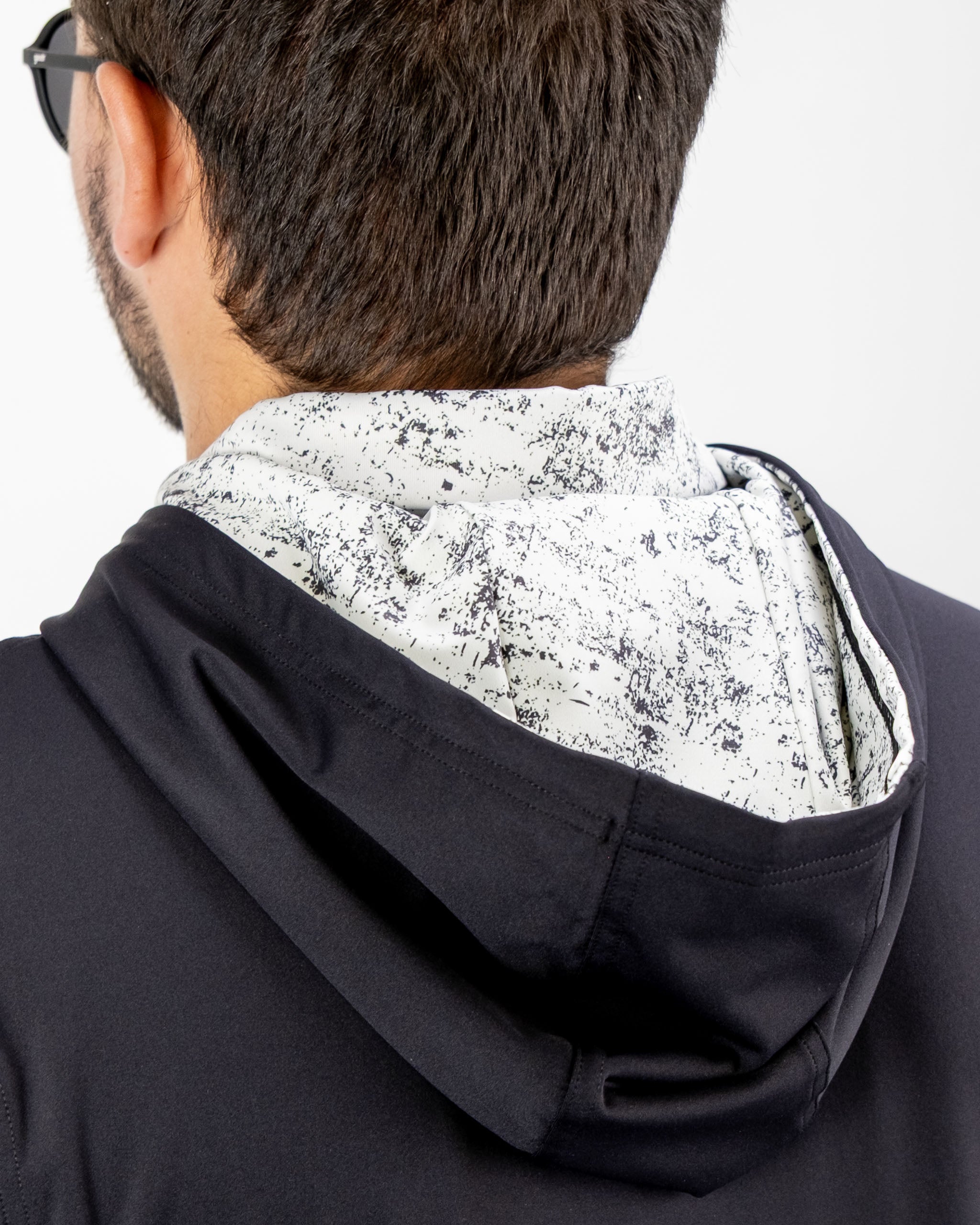 Men's performance golf hoodie featuring a stylish white noise pattern on the hood, perfect for on-course comfort.